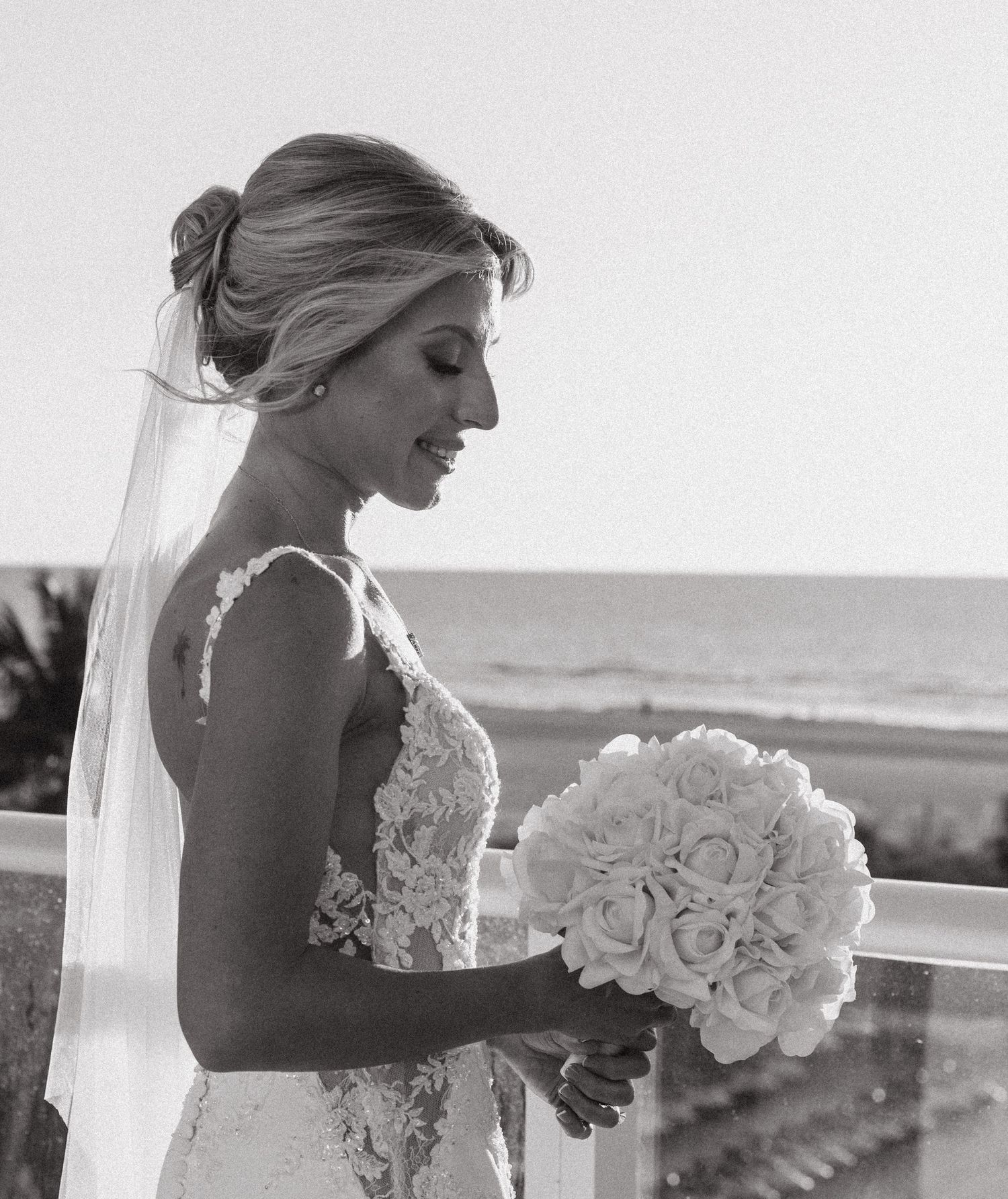 B&W candid photo of a bride during a sunset wedding session