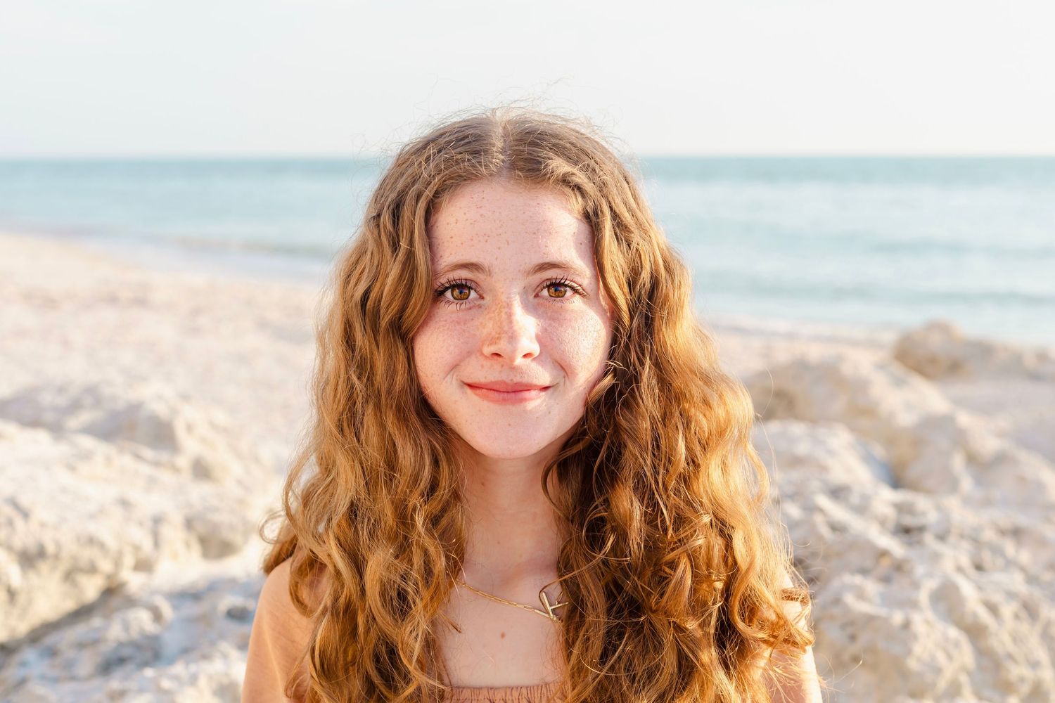 Relaxed beach portrait with calm ocean waters and soft lighting.