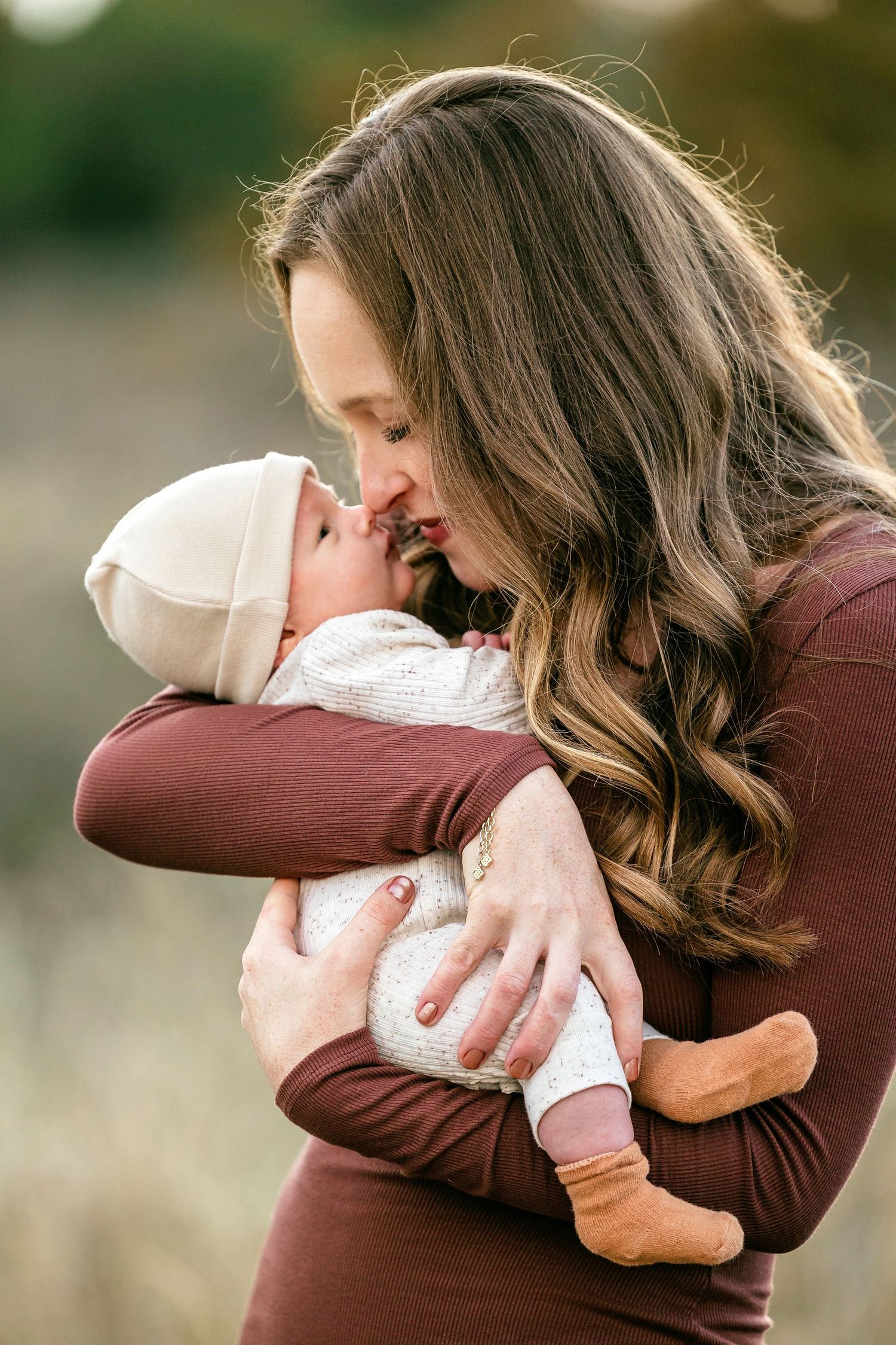 A series of tender embraces captured in profile showing two people hugging in matching brown and white outfits.