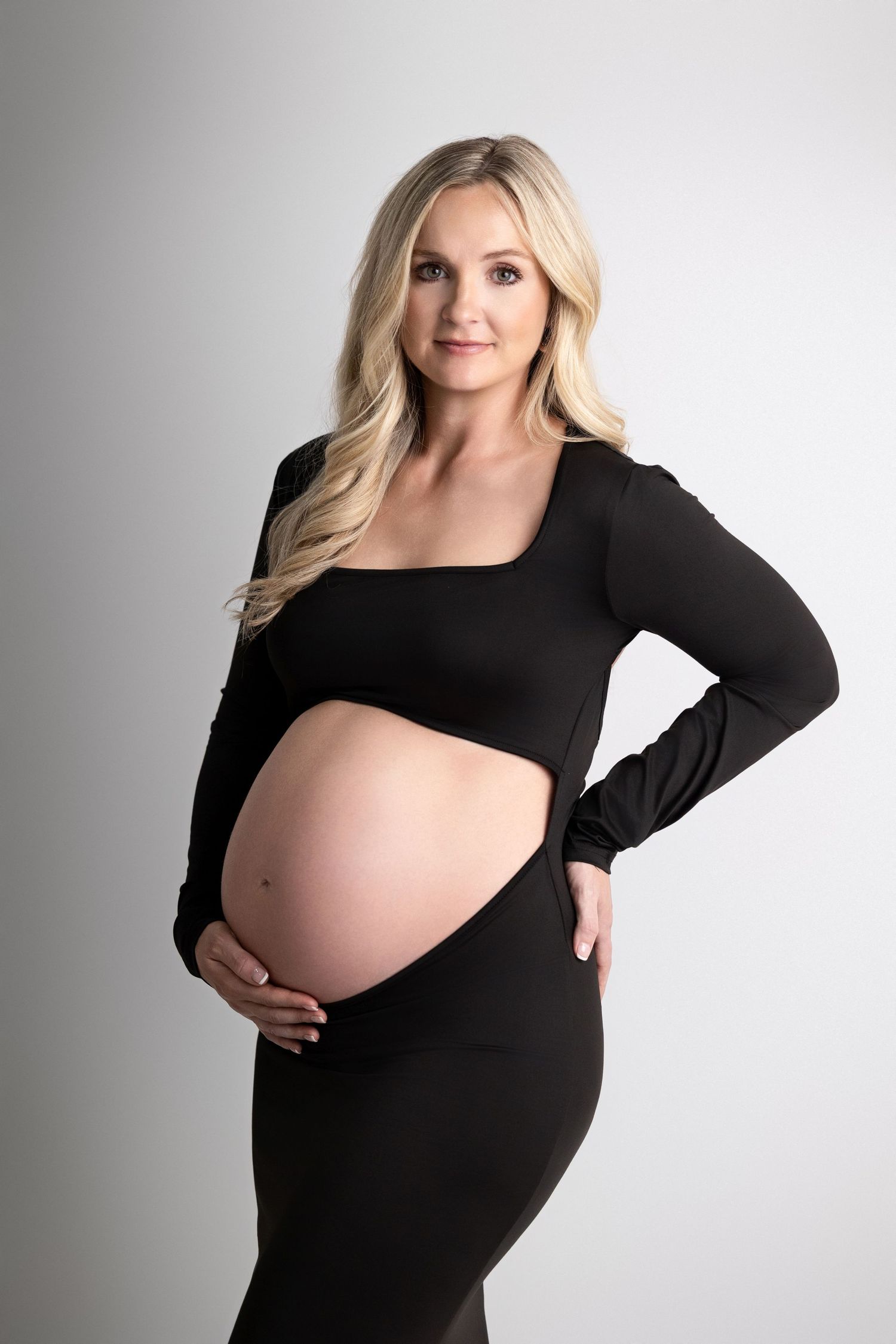 A series of maternity portraits showing a pregnant woman in a black long sleeve dress against a white studio backdrop.