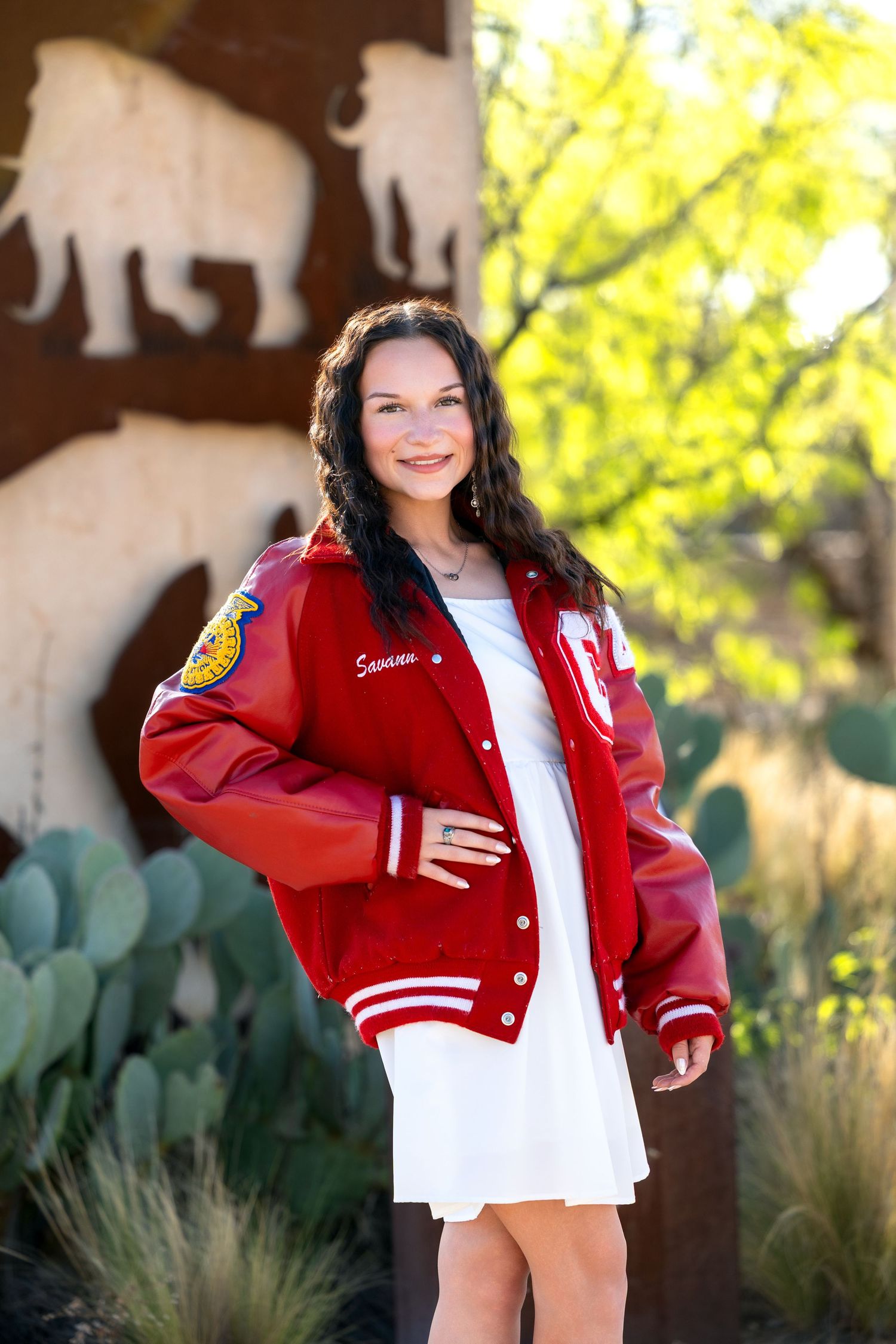 A series of outdoor portrait photos showing someone wearing a red varsity jacket and white top against yellow foliage.