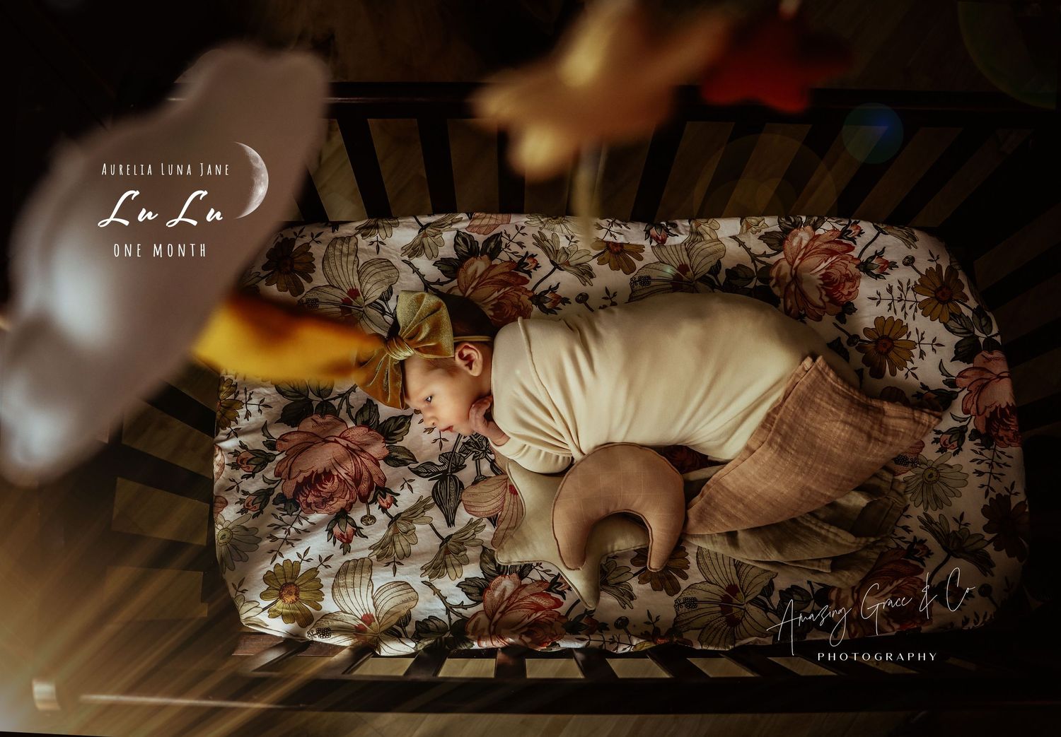 A sleeping infant lies on a floral cushion with warm lighting and vintage-style photography effects.