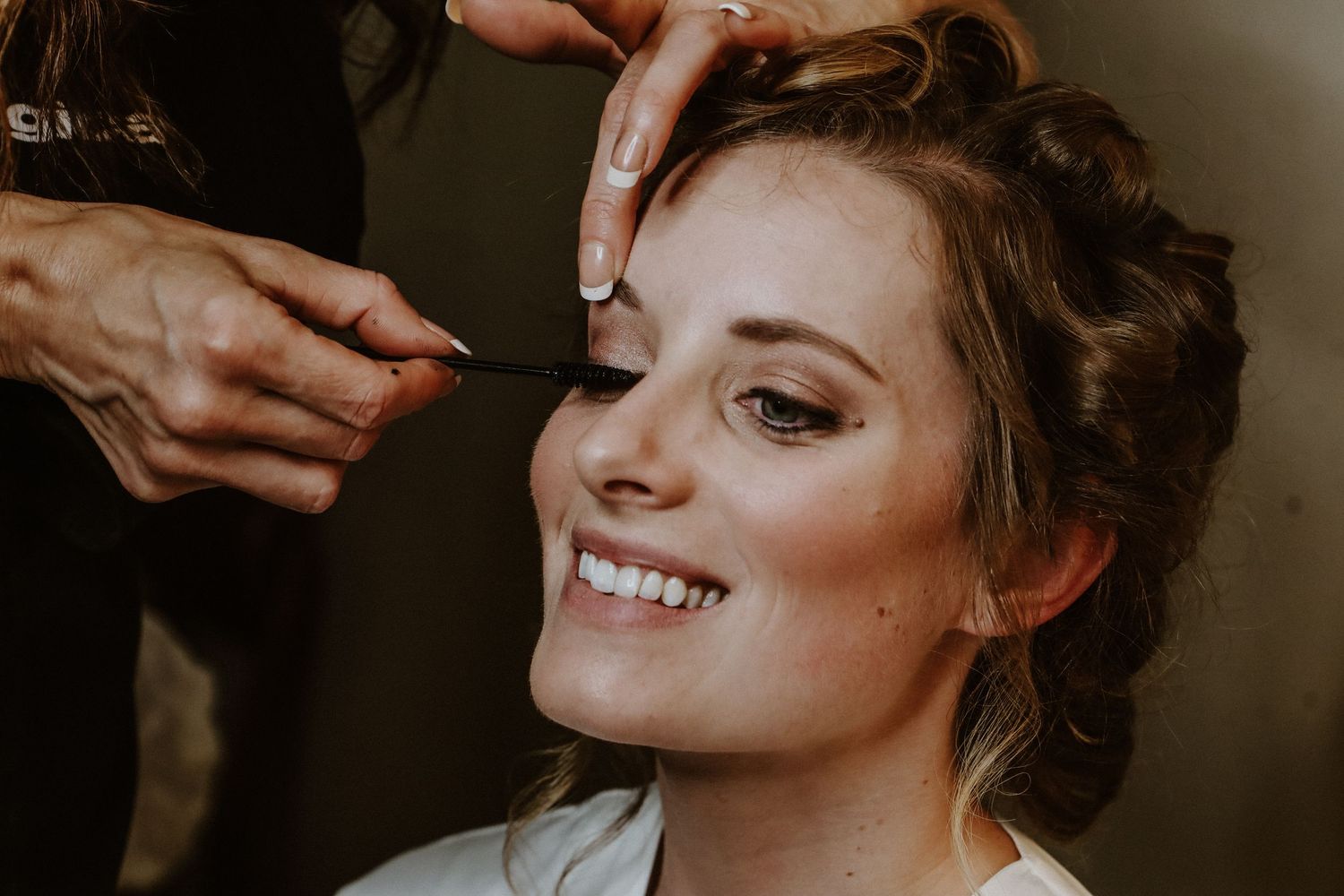 Close-up shot of bridal beauty preparation and styling.