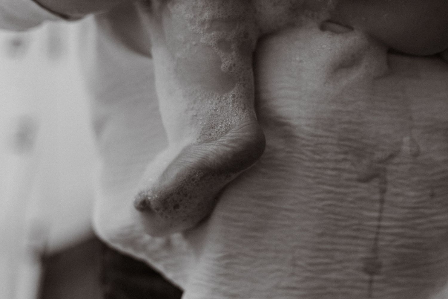 Extreme close-up black and white detail of soft textured fabric or material.