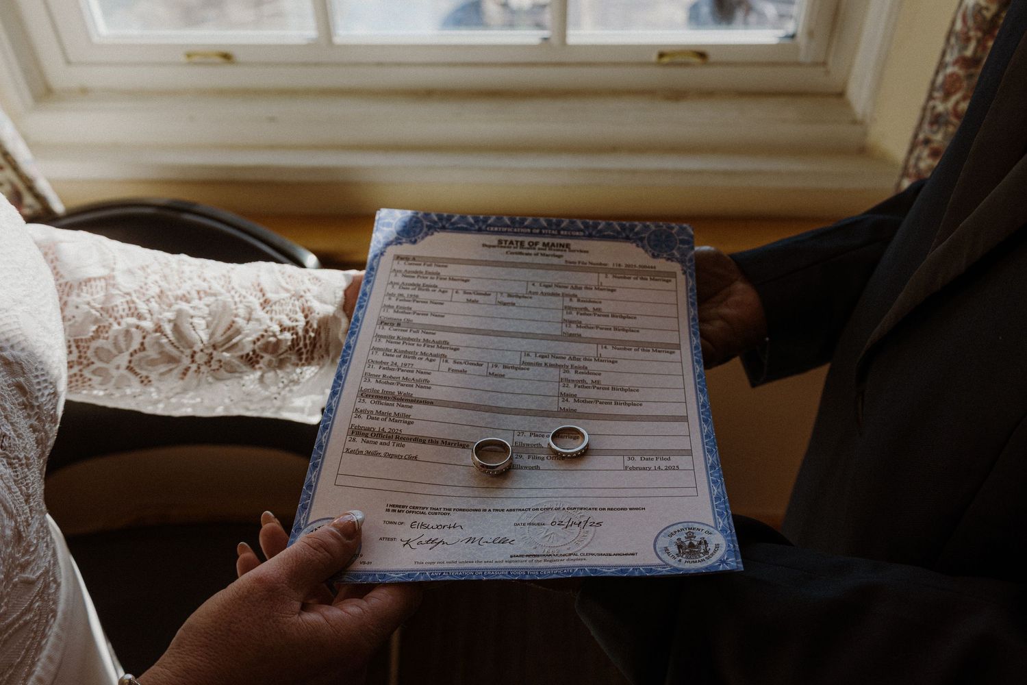 Marriage certificate with wedding rings displayed on official document.