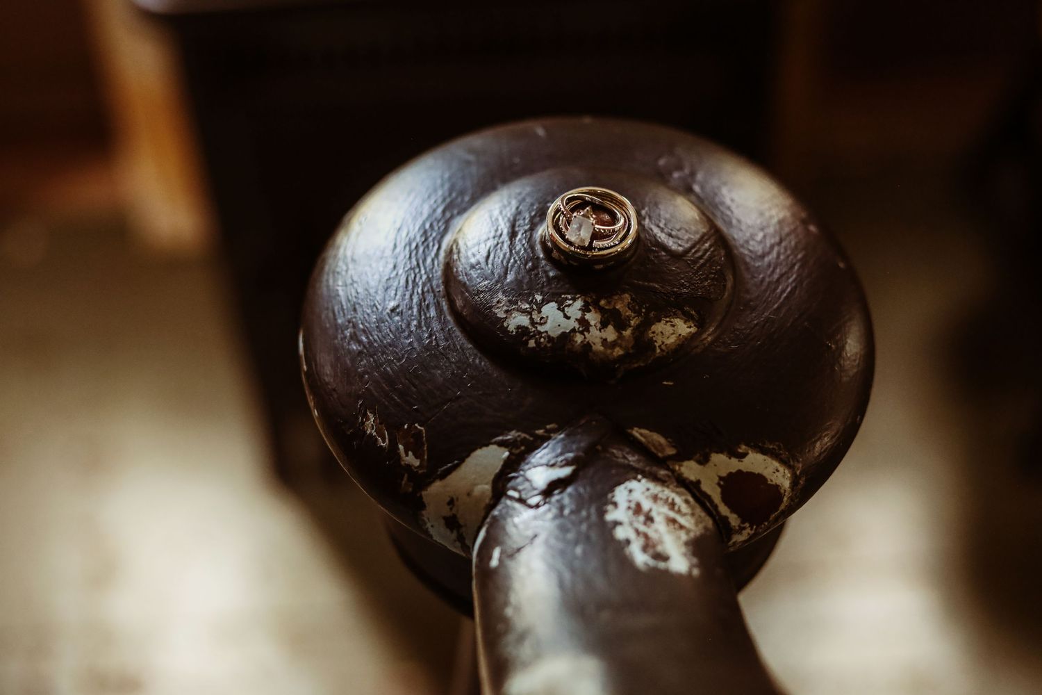 Close-up detail of an ornate dark wooden chair or furniture knob.