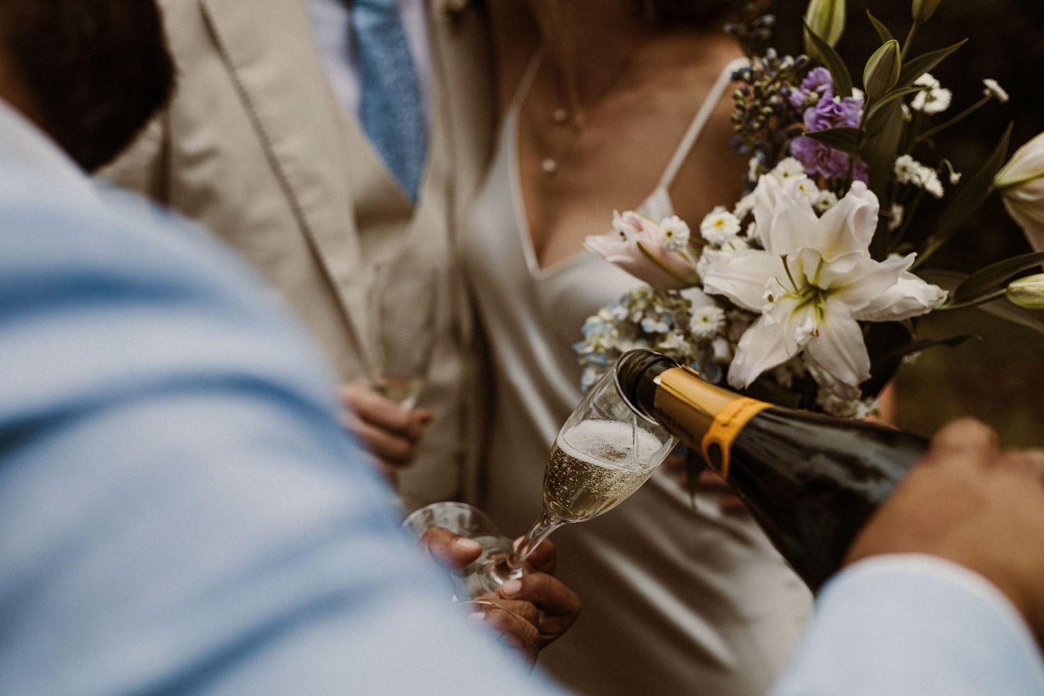 Wedding ceremony detail showing flowers and formal attire during an outdoor celebration.