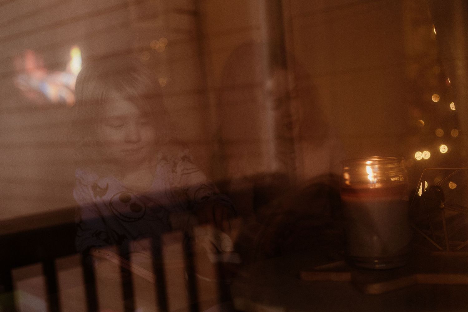 A blurry, dimly lit interior scene with chairs and soft glowing lights creating a moody atmospheric ambiance.