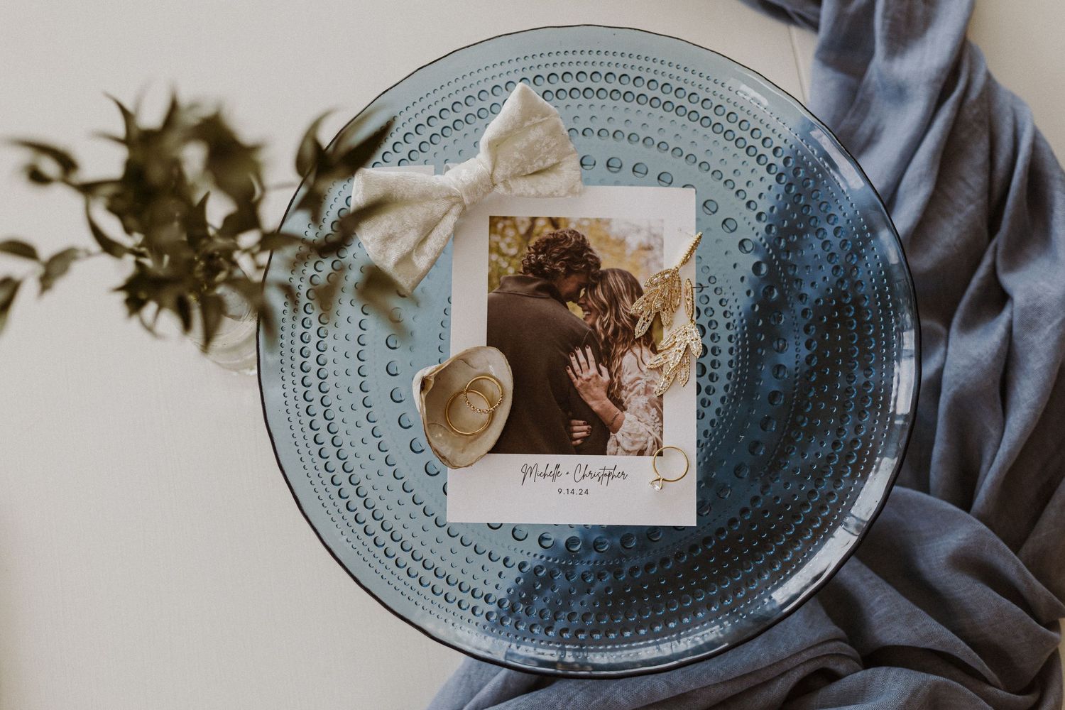 A vintage photo and decorative items arranged on blue textured glass plate.