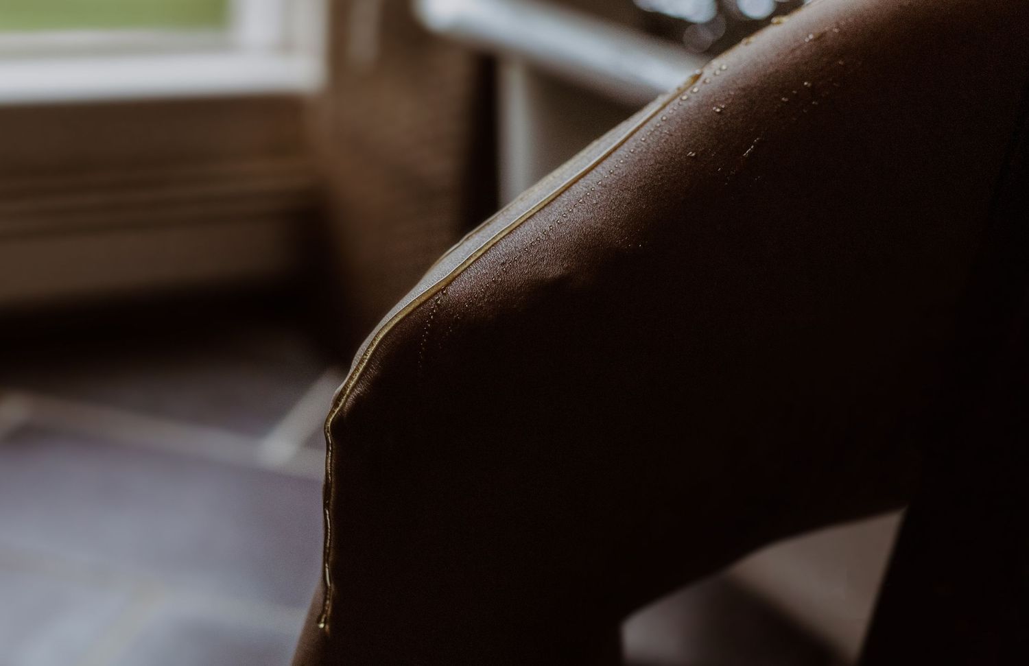 Artistic silhouette photograph showing dark shadows and muted lighting near a window.
