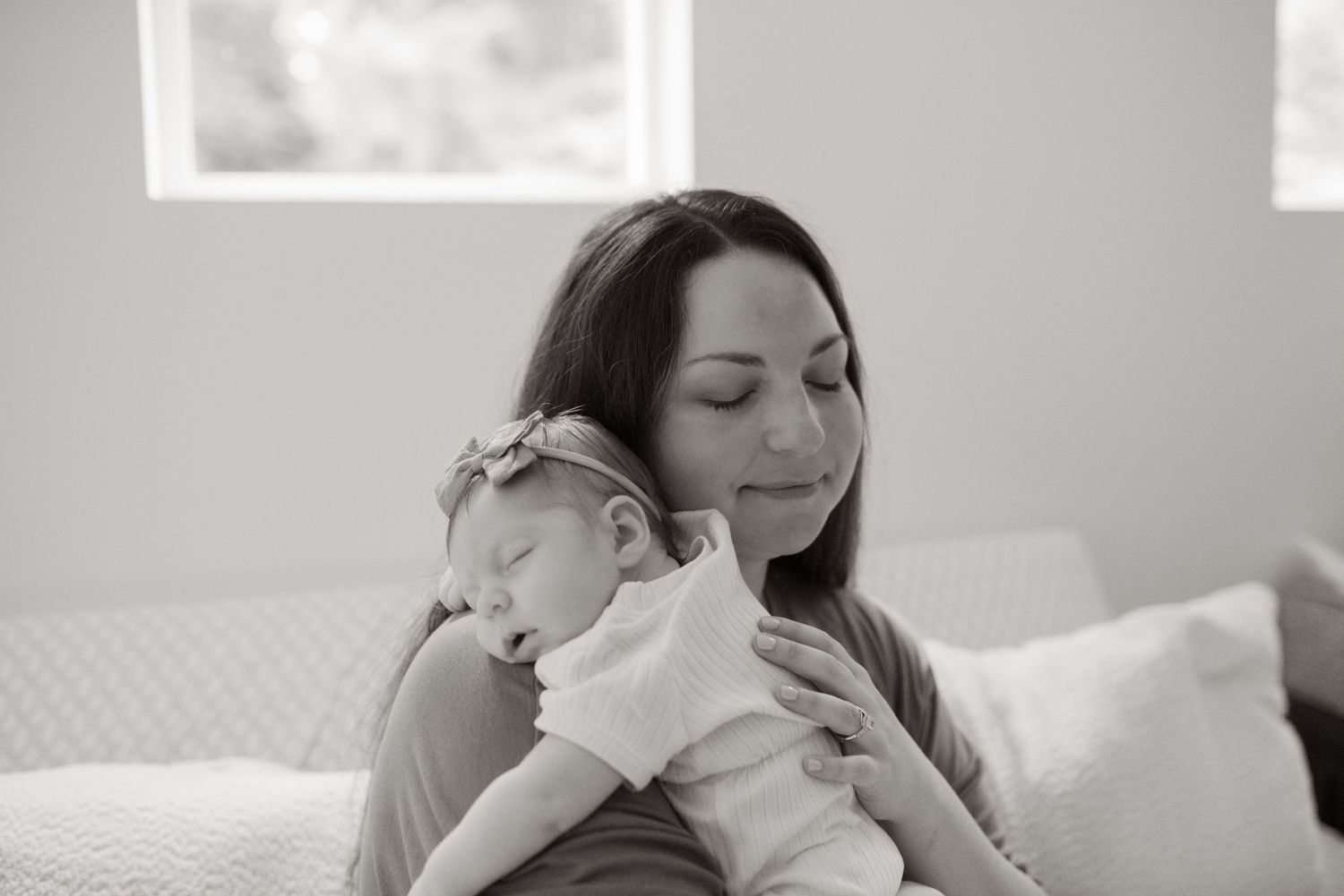 newborn on mothers shoulder