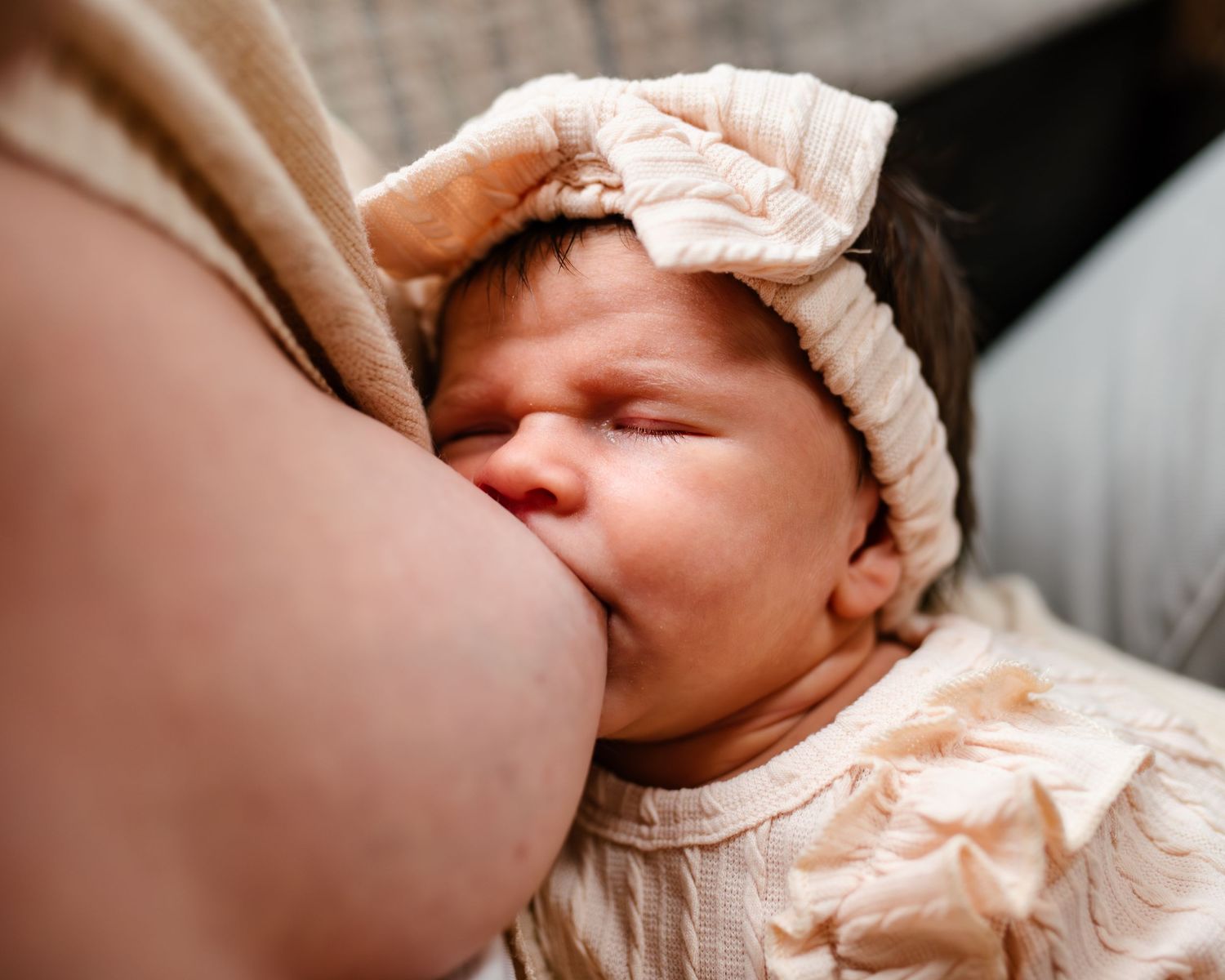a newborn baby nursing during a newborn photography session