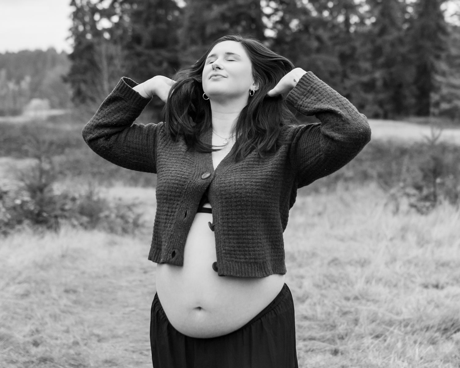solo shot of mom during her maternity session. She is playing with her hair