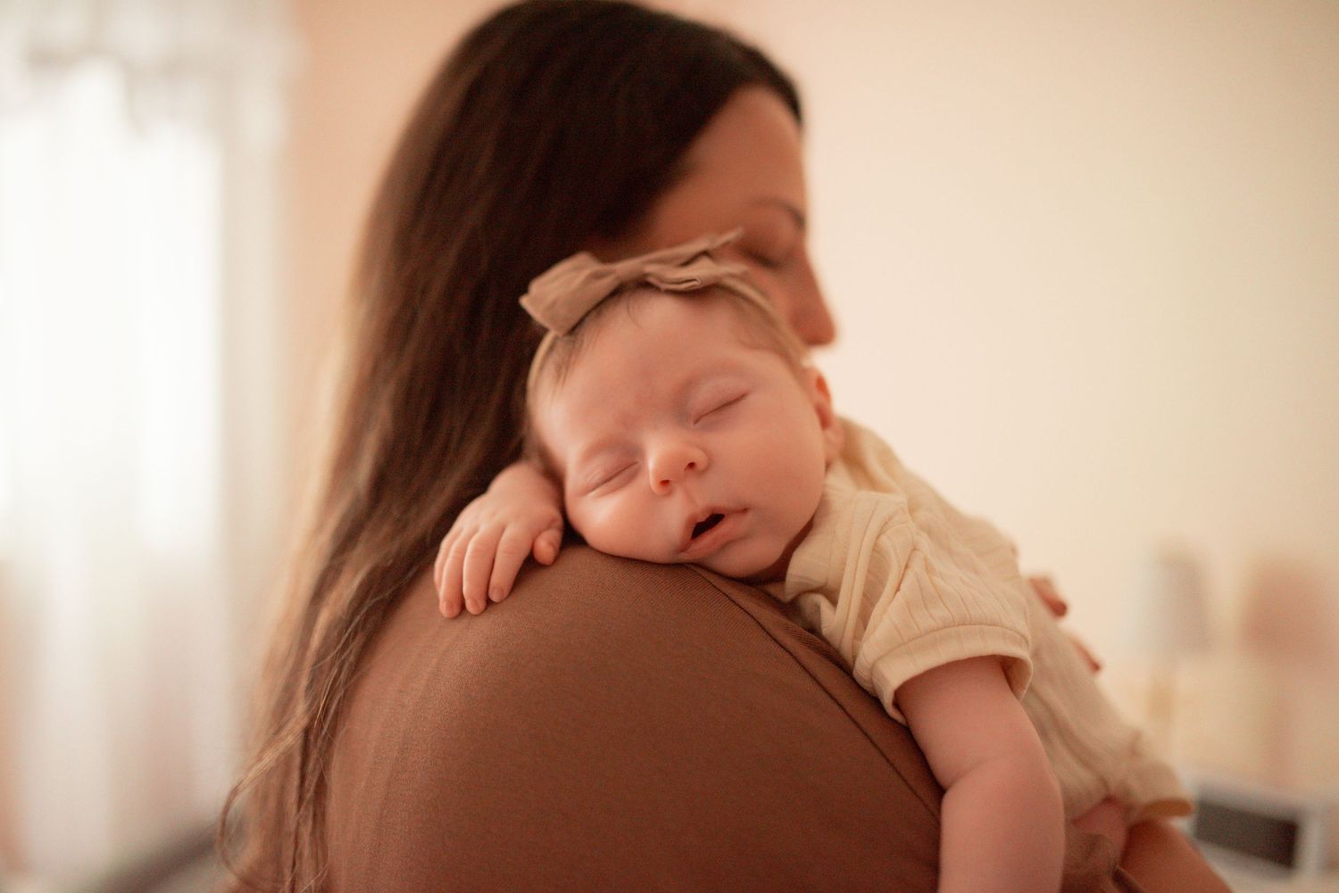newborn asleep on mom