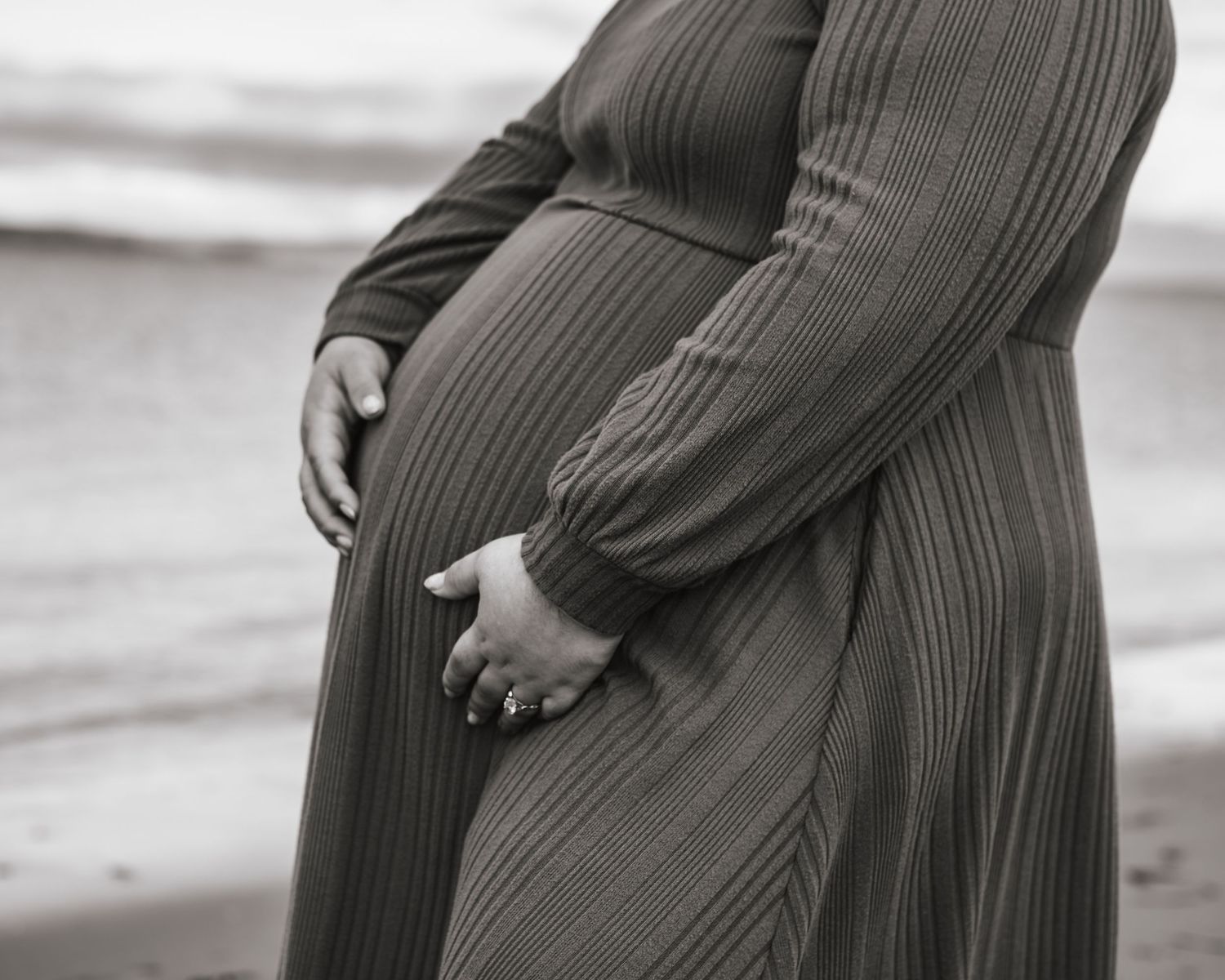 mom holding her belly during maternity session