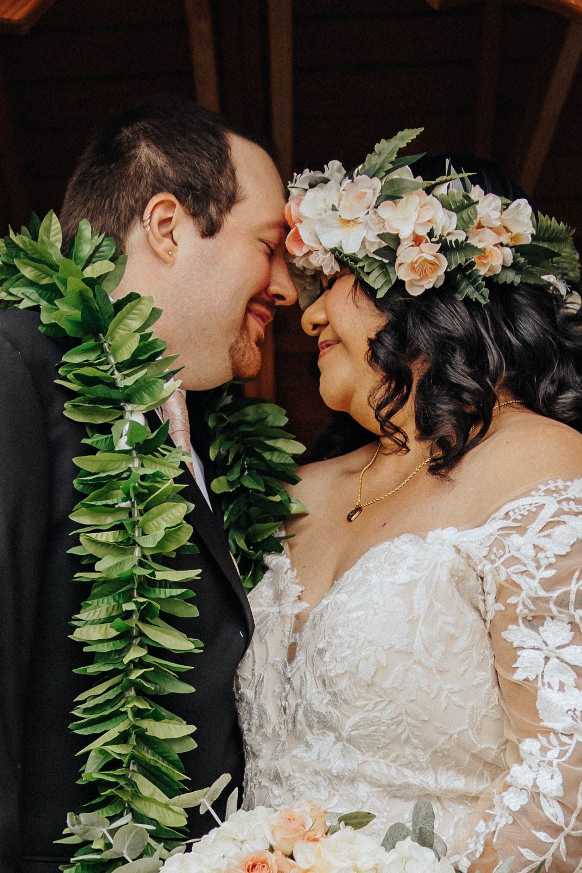 Close-up scene depicting tender romantic moment surrounded by lush green foliage and delicate flowers.