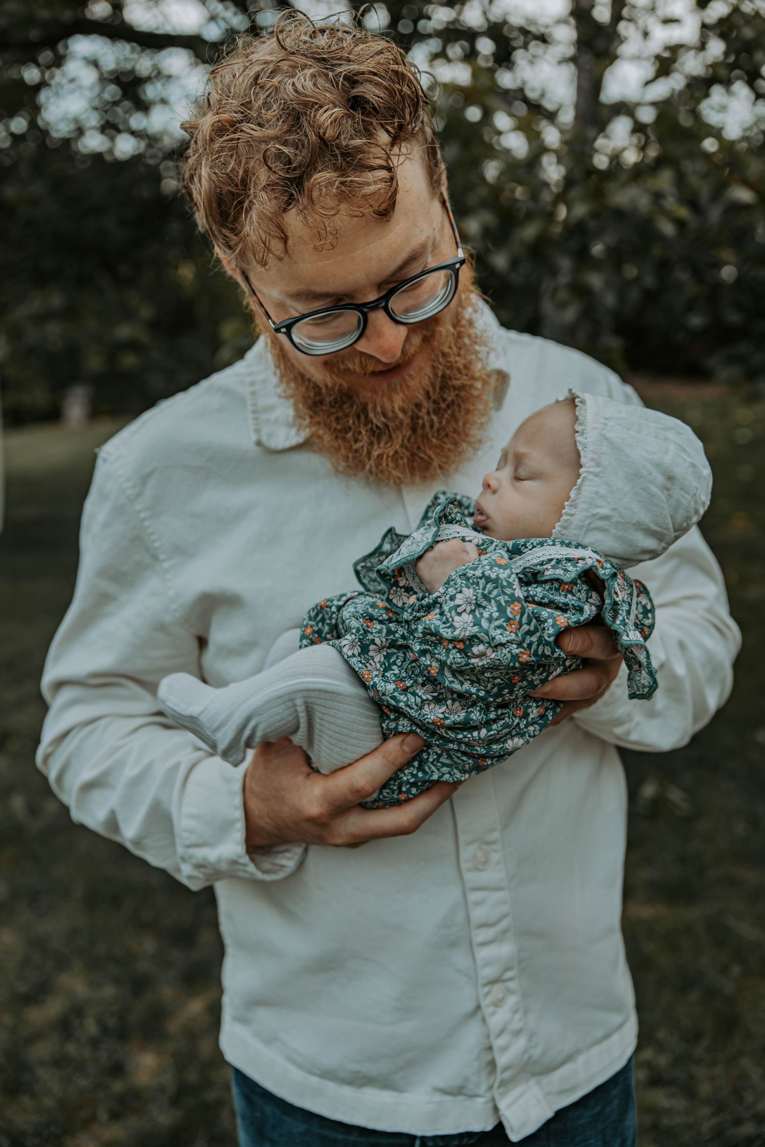 Person in white shirt holds a baby wrapped in teal floral swaddle in series of matching photos.