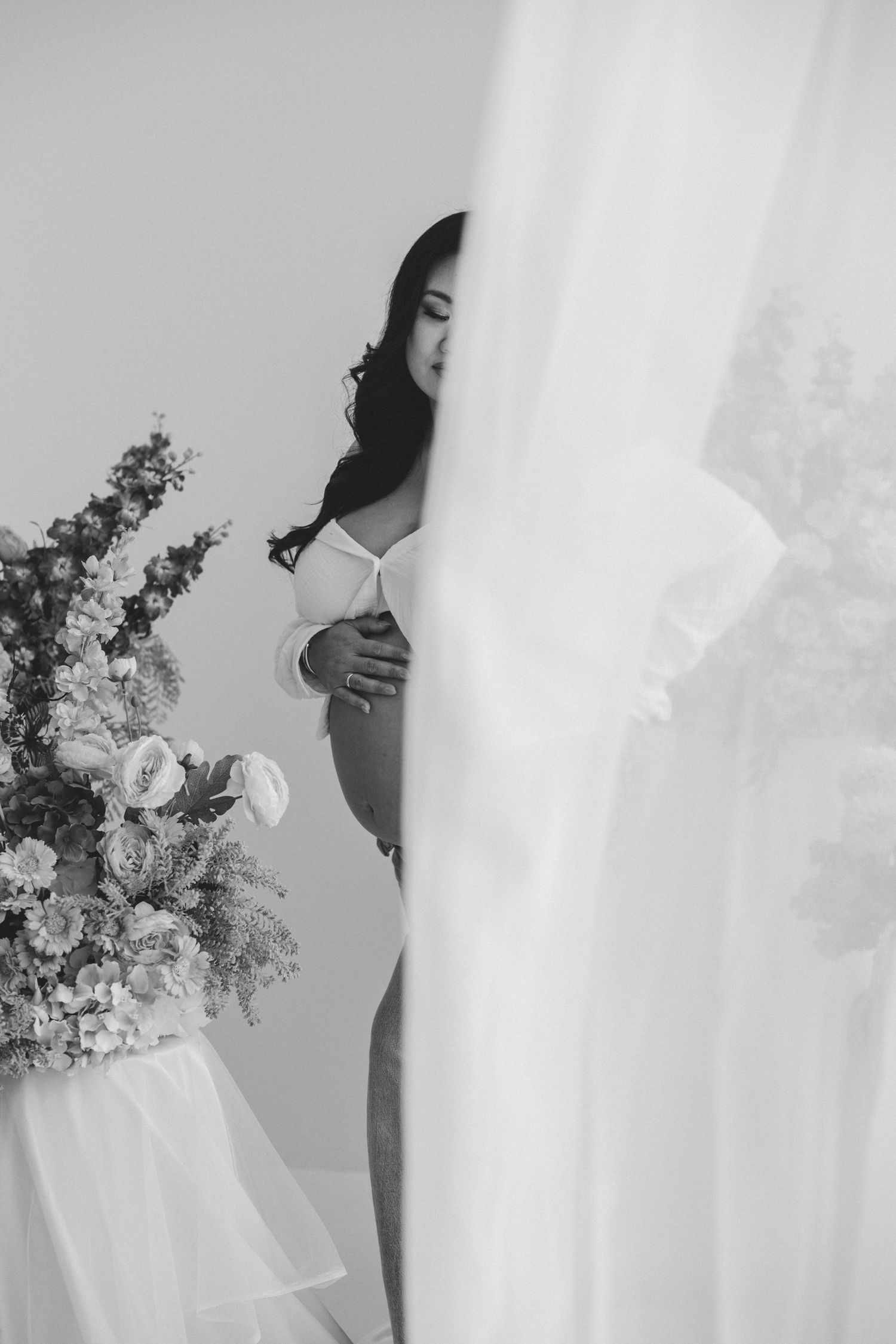 Black and white wedding photography series showing elegant bridal details with flowing veil and floral bouquet.