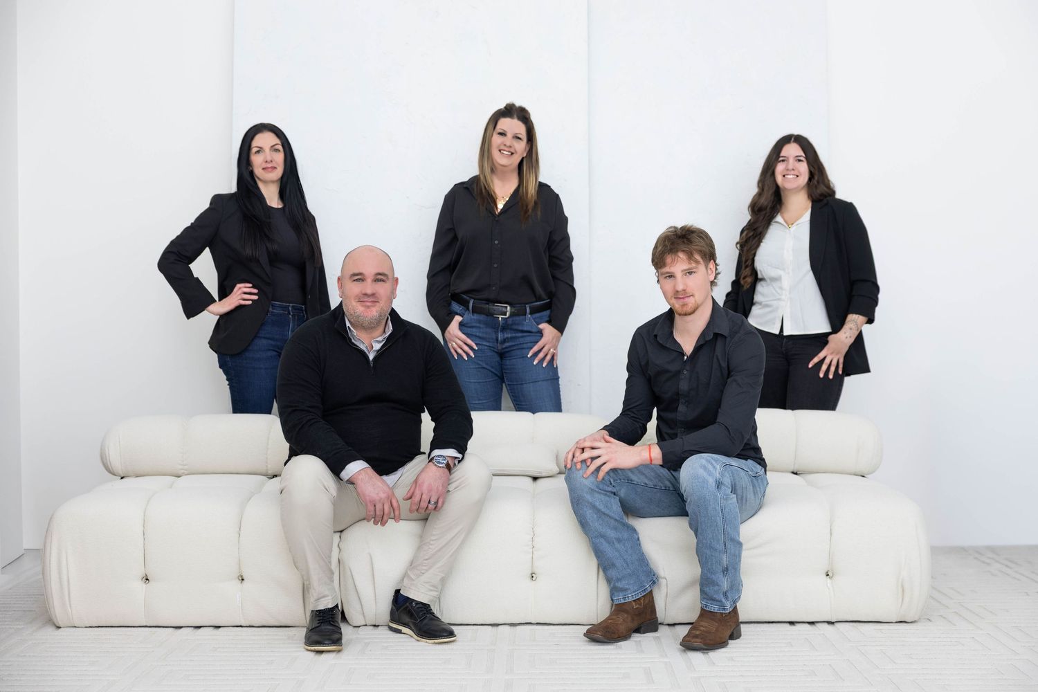 A series of six connected photos showing people sitting and posing on a white couch in a studio setting.