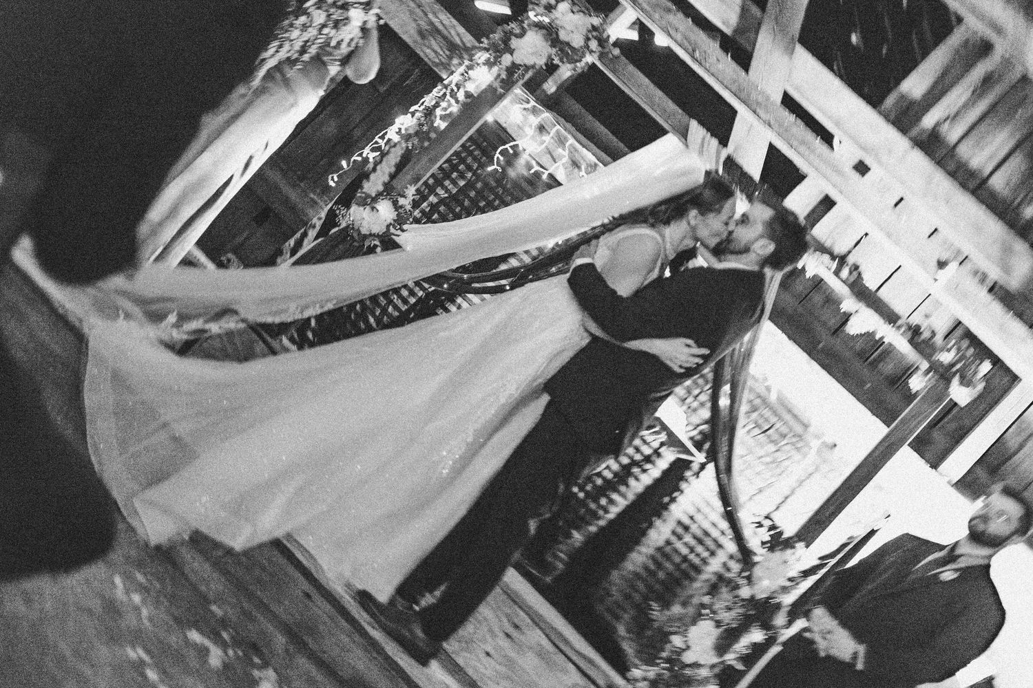 Black and white photo of a vinyl record player spinning during a wedding reception.