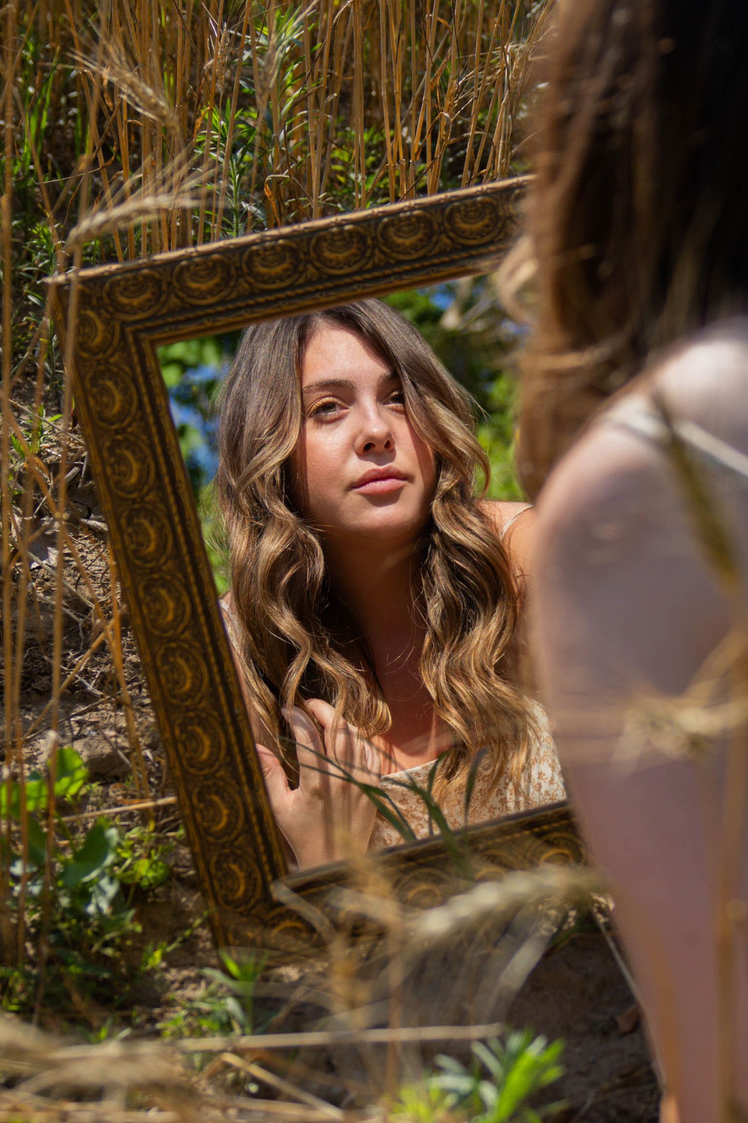 A photoshoot among natural foliage features dreamy artistic portraits with soft lighting and bokeh effects.
