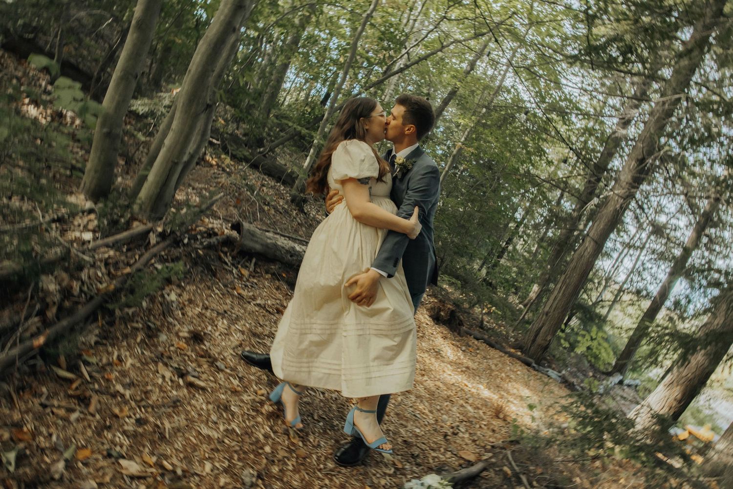 Multiple wedding photography shots showing tender moments between a couple among trees and fallen leaves.