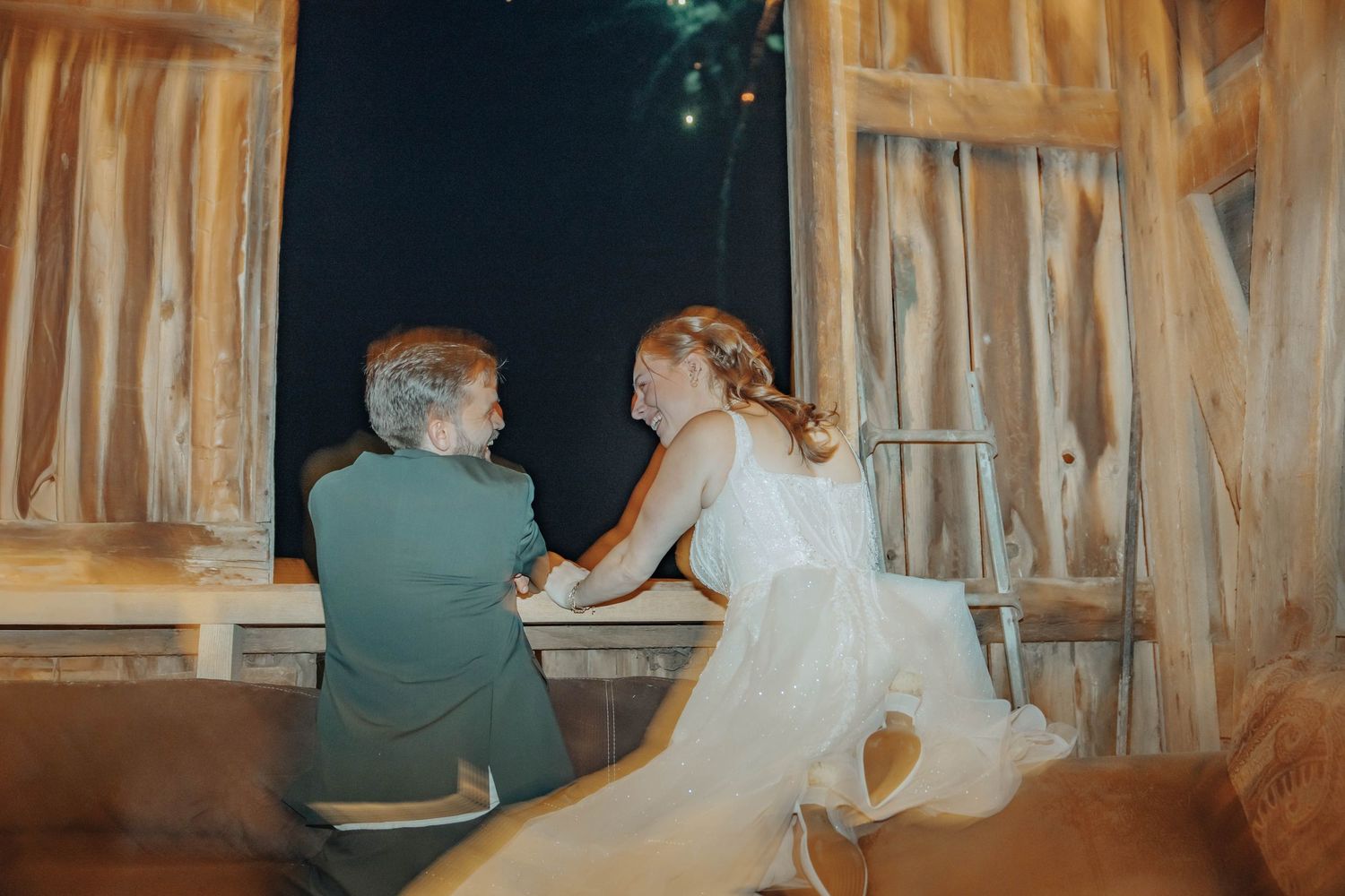 A bride and groom share an intimate moment together during their rustic barn wedding reception.