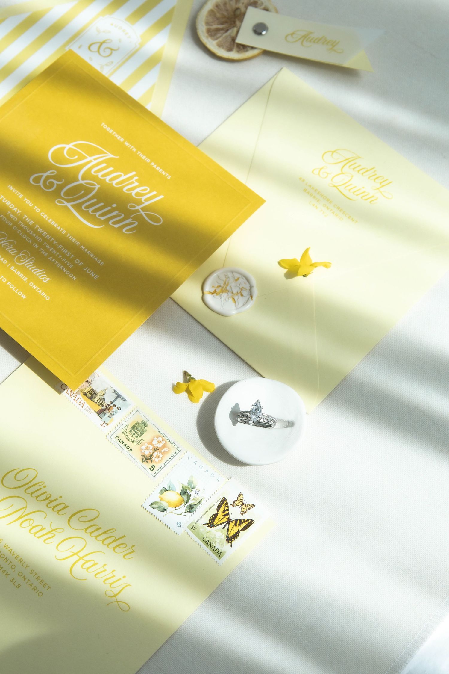 Wedding stationery in gold and cream colors with butterfly motifs and elegant typography.