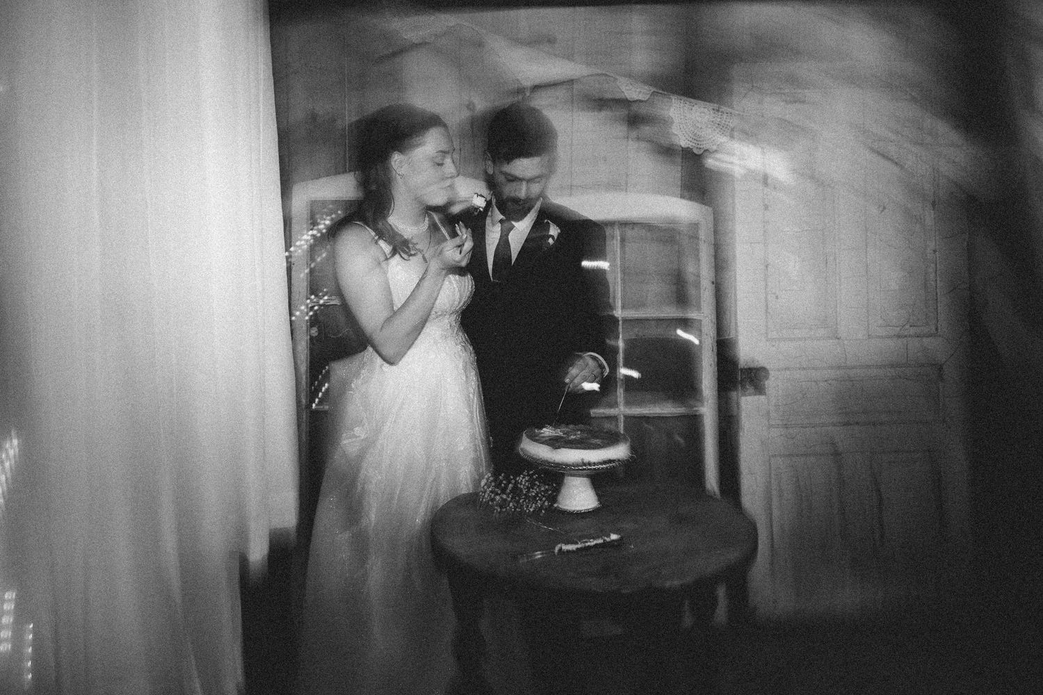 A black and white film strip showing four sequential frames of a couple dancing at what appears to be a formal event.