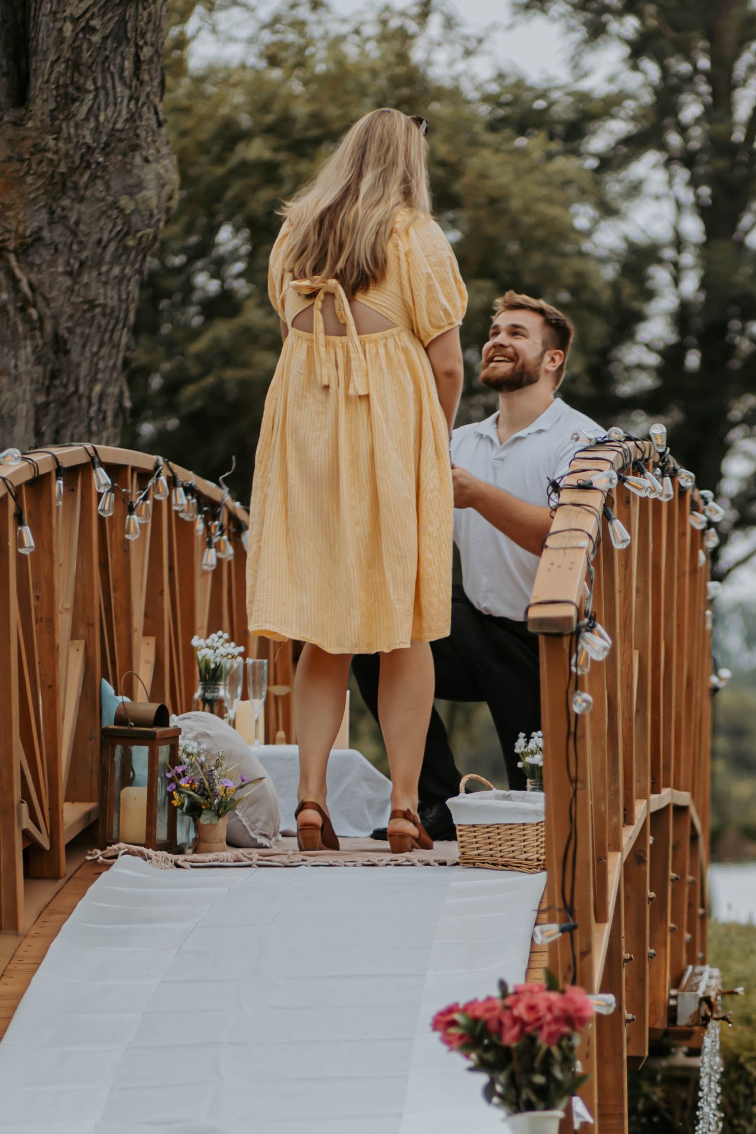 A collage of outdoor dining tables with wooden chairs and yellow tablecloths set up for a rustic wedding reception.