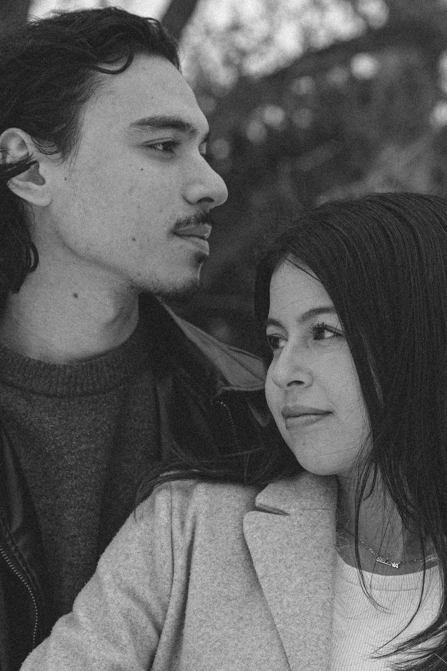 A series of intimate black and white photos showing a couple in tender romantic moments together.