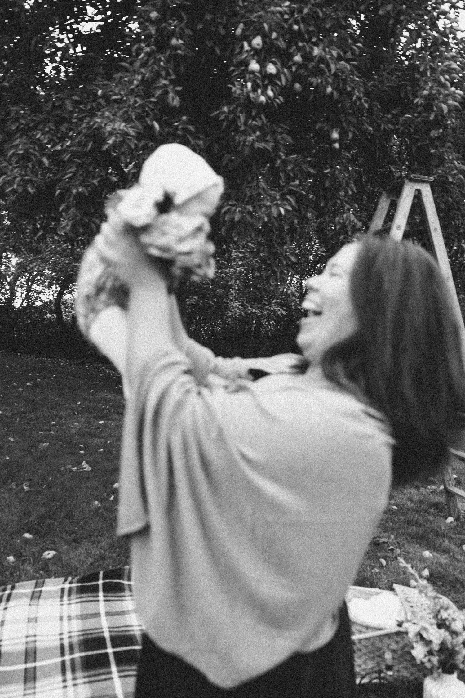 Series of black and white photos showing loving family interaction outdoors.