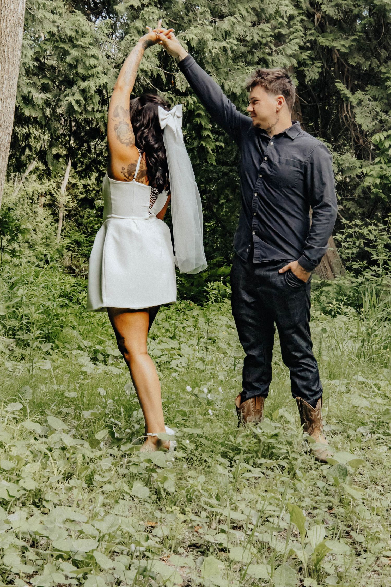 Dancing and twirling movements captured in a series of candid shots in a green forest setting.