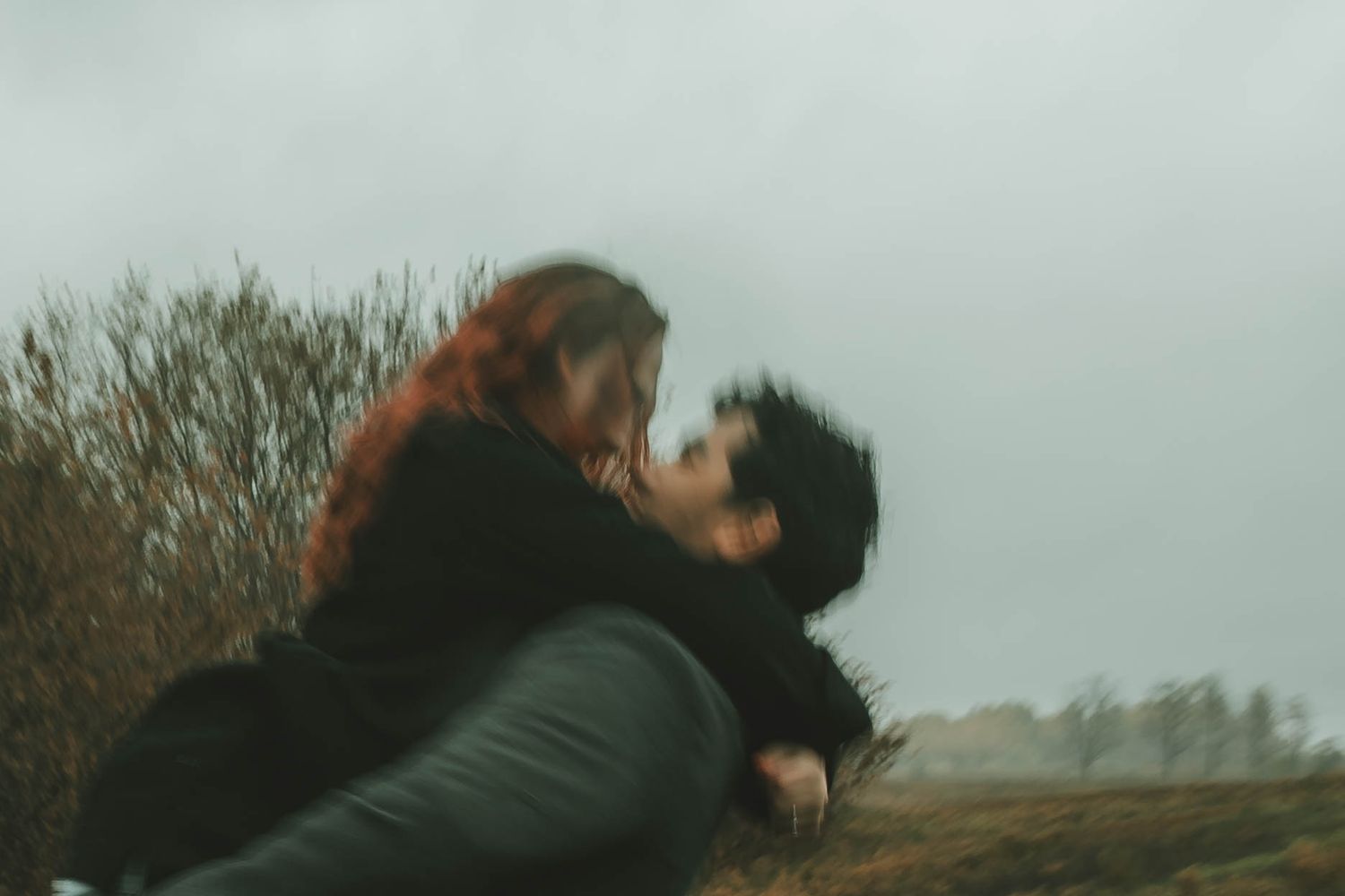 A cinematic sequence showing a figure falling backwards in slow motion against a moody outdoor background.