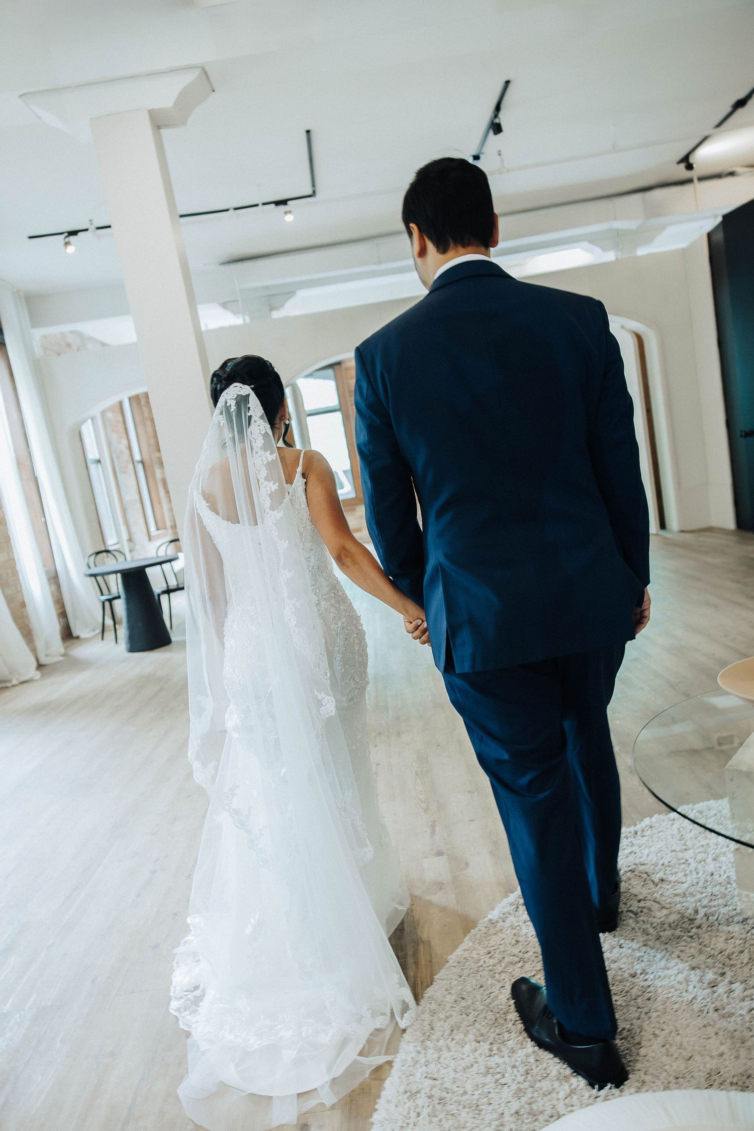 A series of wedding photos showing a bride in a white dress walking behind a groom in a navy blue suit.