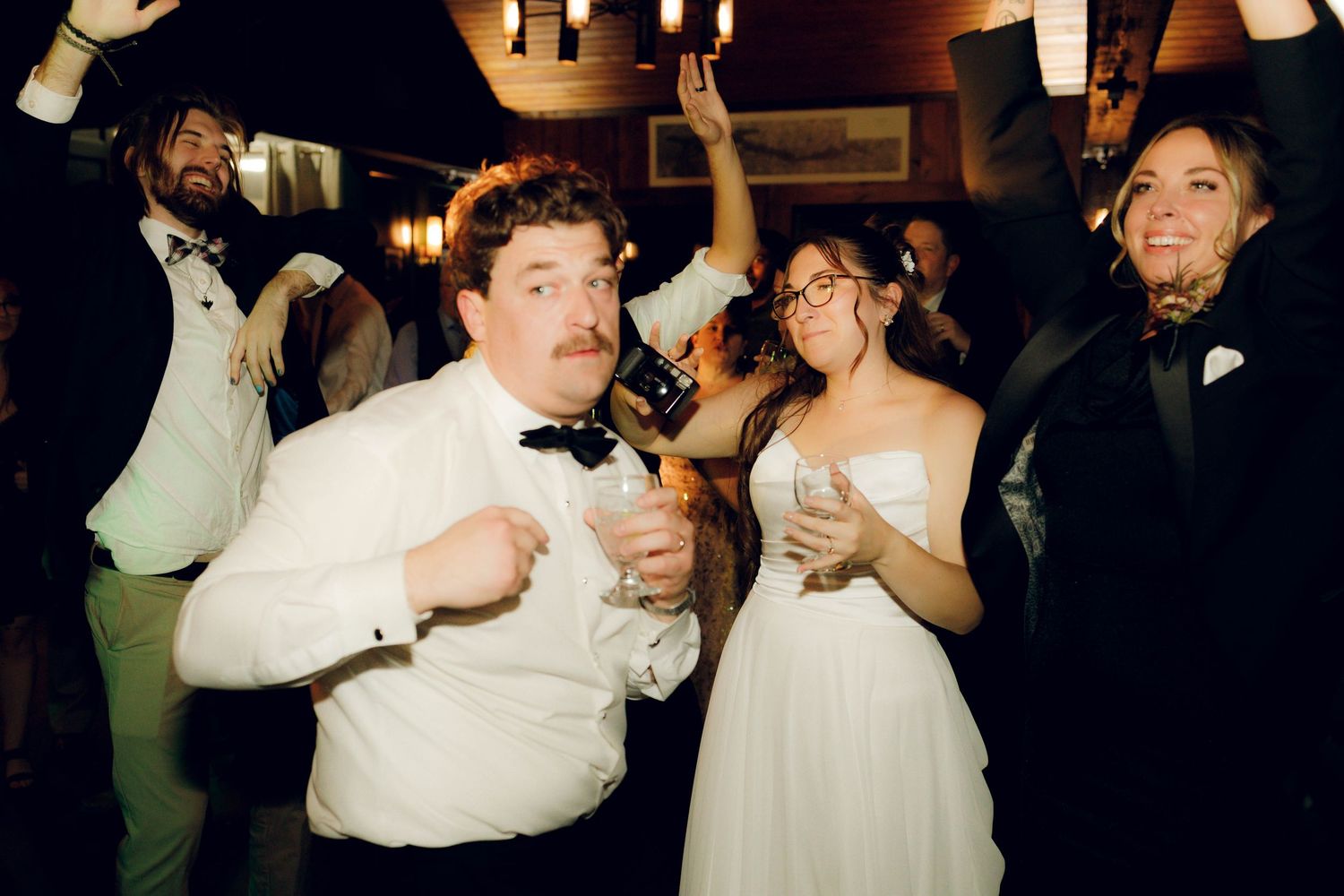 A series of candid party photos showing people dancing and celebrating at what appears to be a wedding reception.