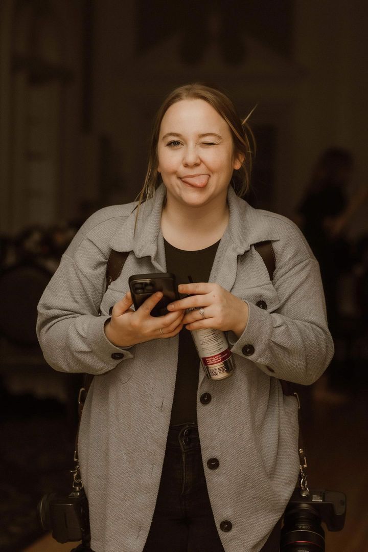 A series of photos showing someone in a gray jacket holding and looking at their phone in dim lighting.