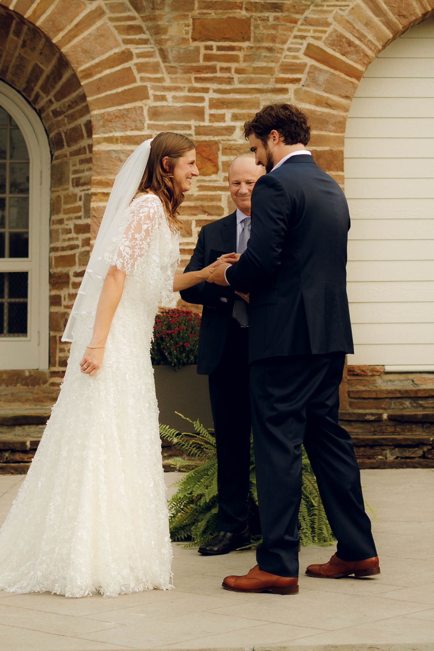 A series of wedding ceremony moments captured at a rustic brick church entrance showing interactions during the service.