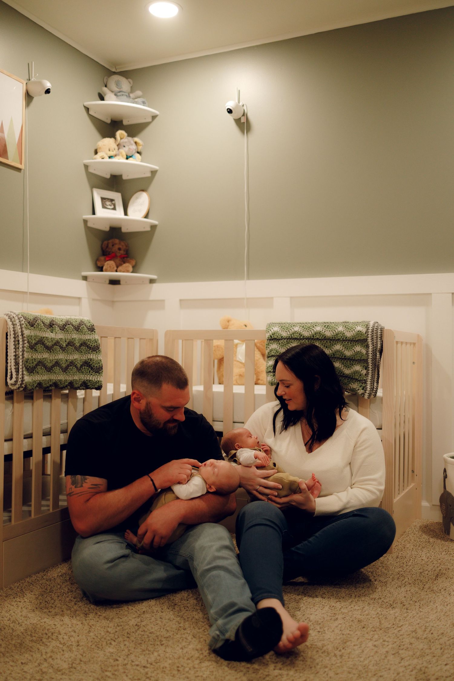 A series of candid family moments showing parents and baby interacting while sitting on a carpeted floor in a nursery.