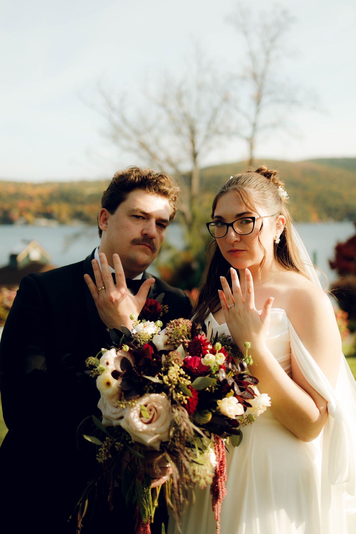 A series of candid wedding photos showing a couple posing together with autumn foliage and floral bouquets in the background.
