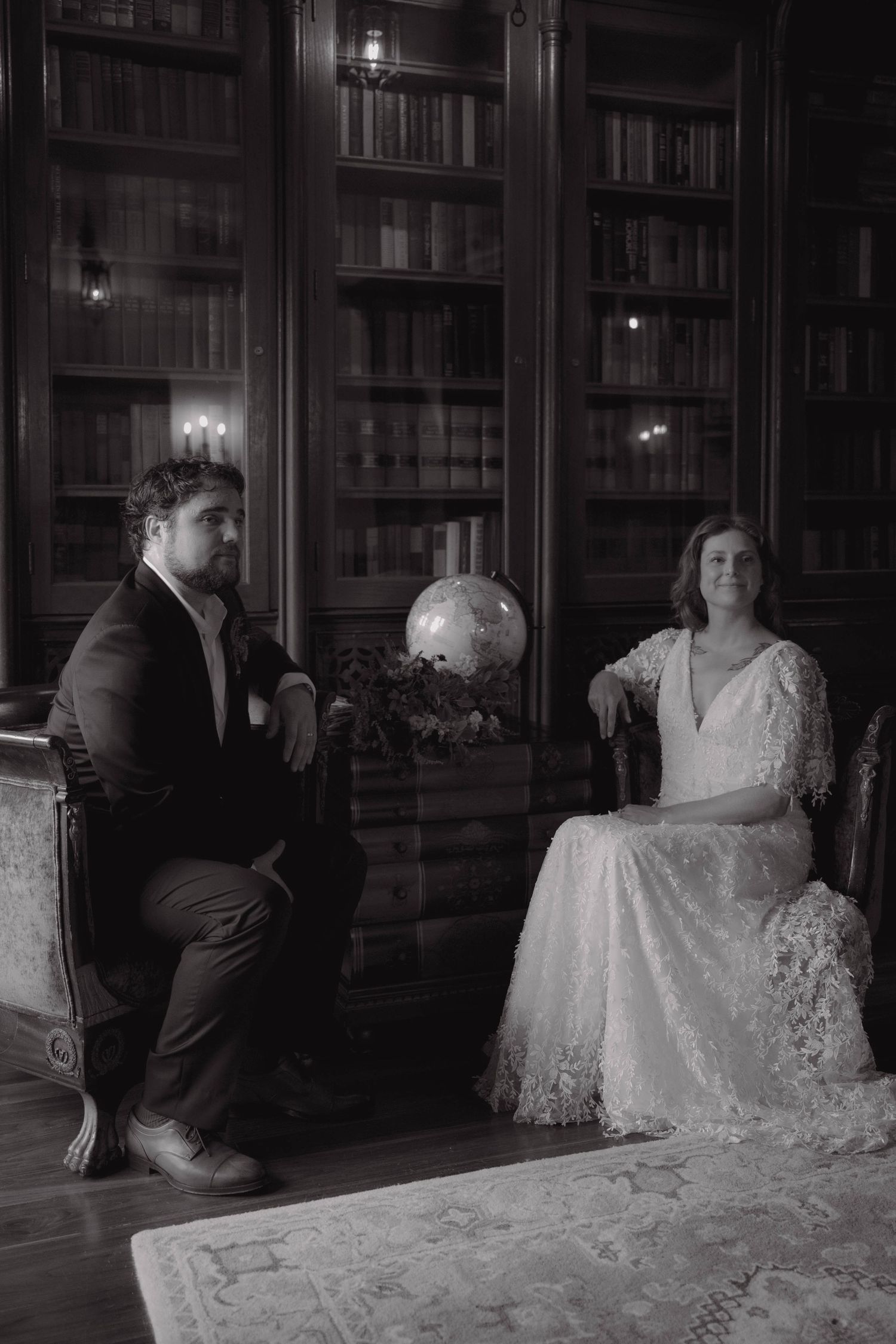 A series of five vintage black and white photographs showing a couple in formal attire sitting in an elegant library setting.