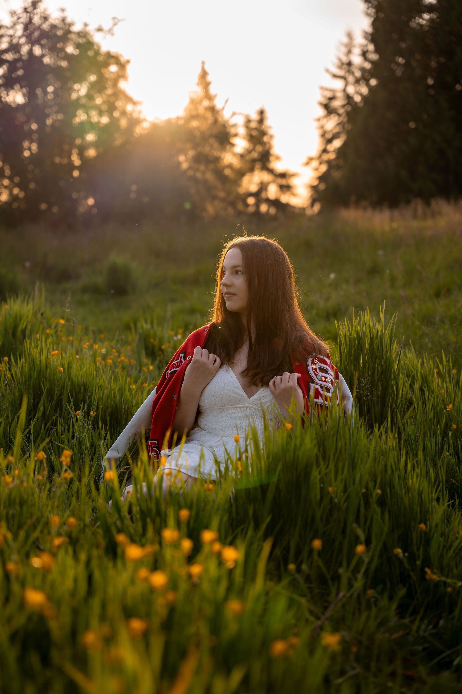 A peaceful sunset portrait in a meadow filled with wildflowers and golden light.