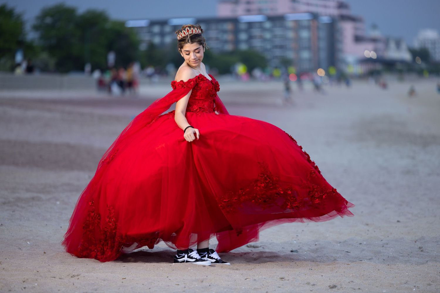 Stunning red ball gown captured in series of photos at outdoor location during golden hour.