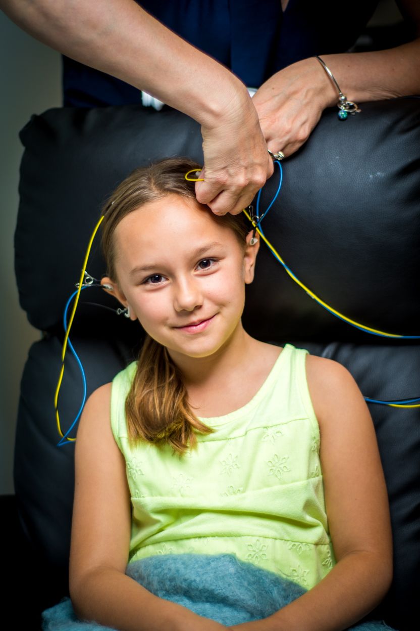 A sequence of photos showing someone getting their hair braided with neon-colored string against a dark background.