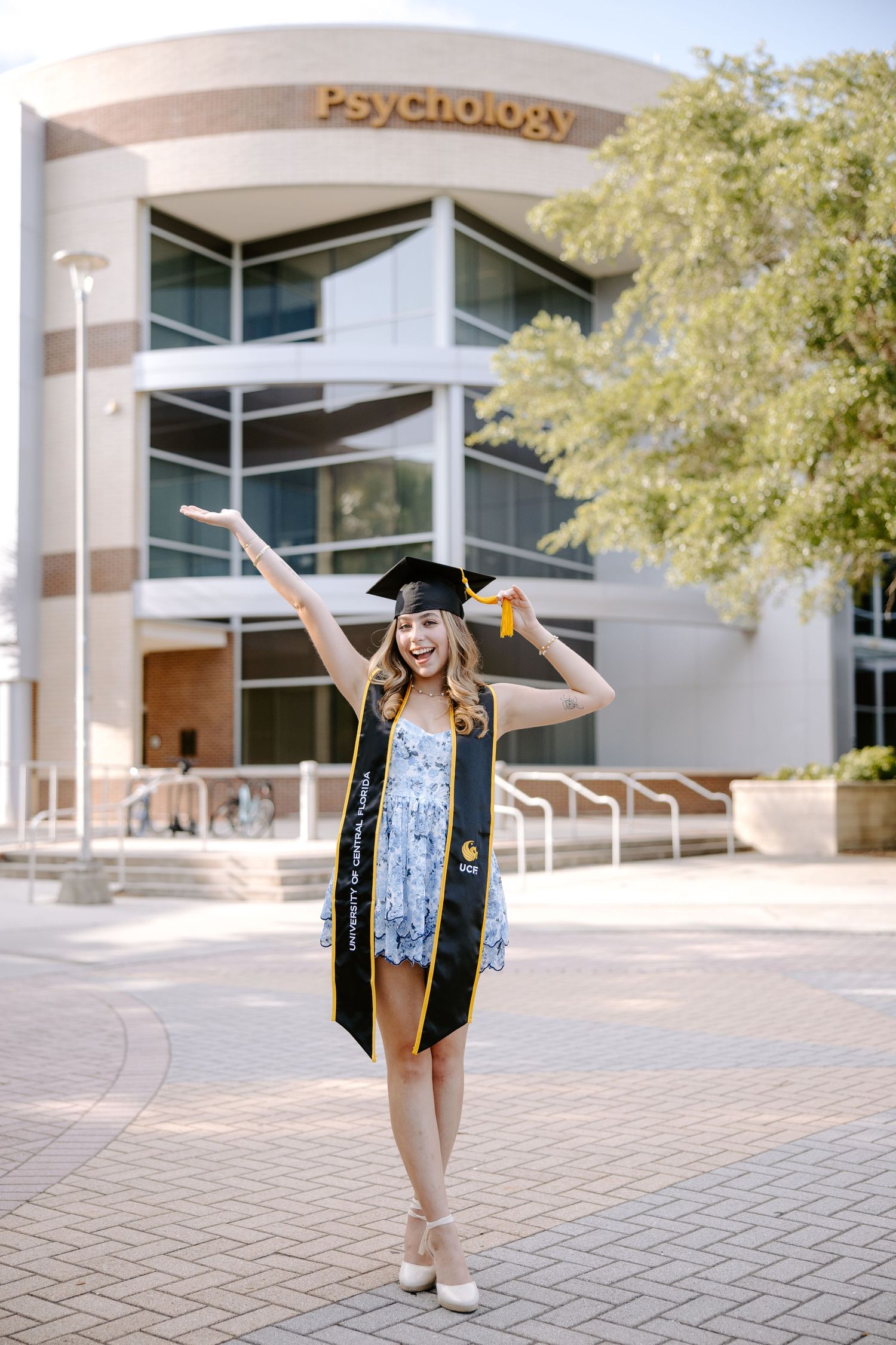 Graduation celebration photos in front of the Psychology building with academic regalia.