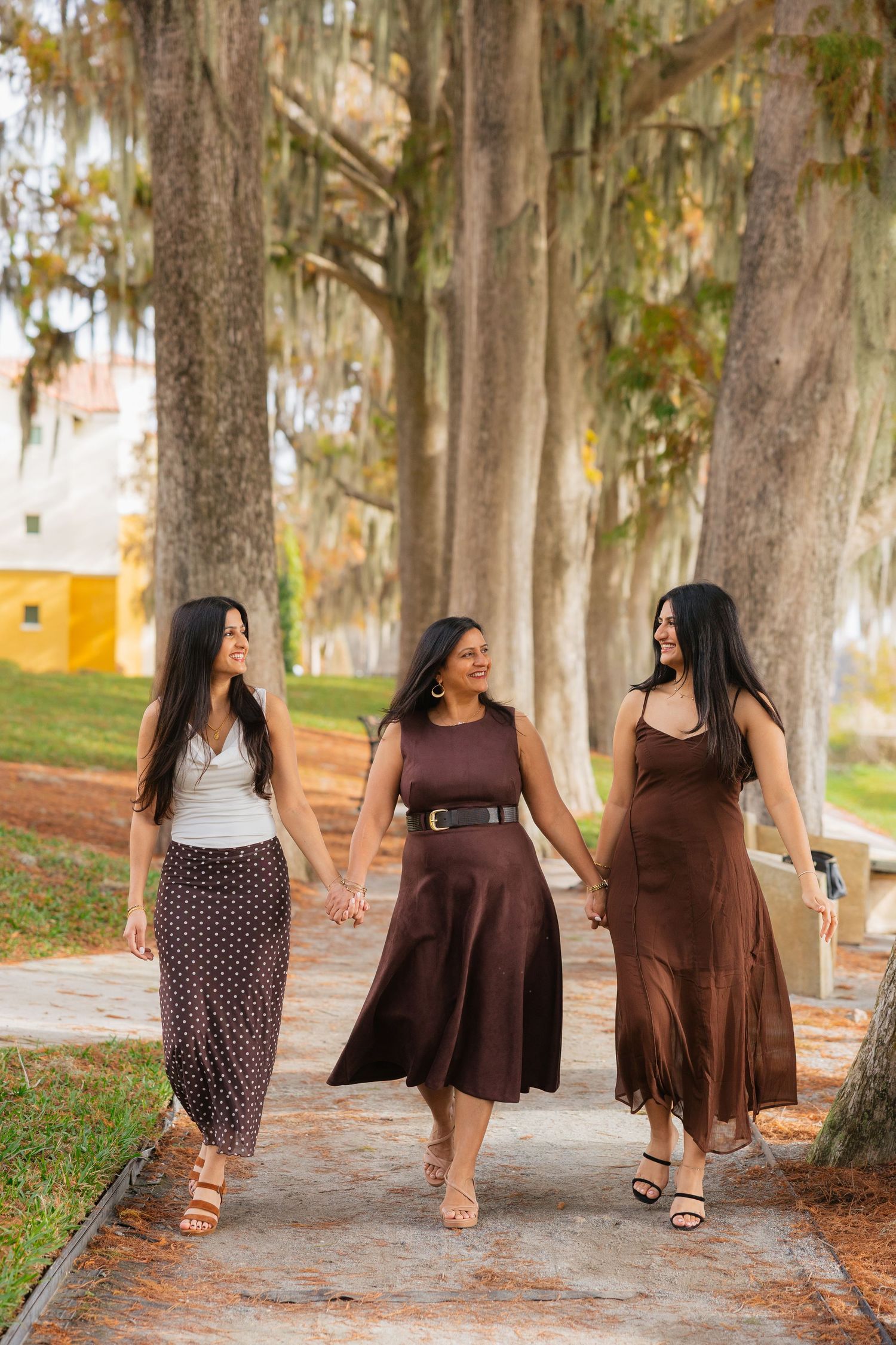A sequence of four photos showing brown dresses and polka dot outfits on a tree-lined path during autumn.