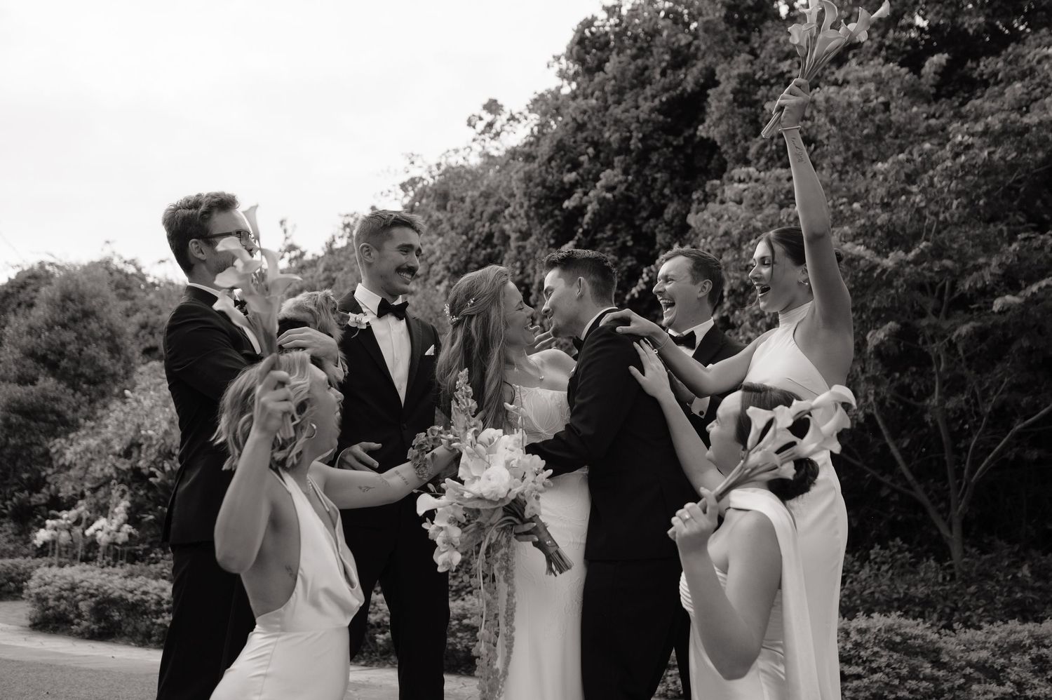 Black and white wedding ceremony candid moments captured in a garden setting.