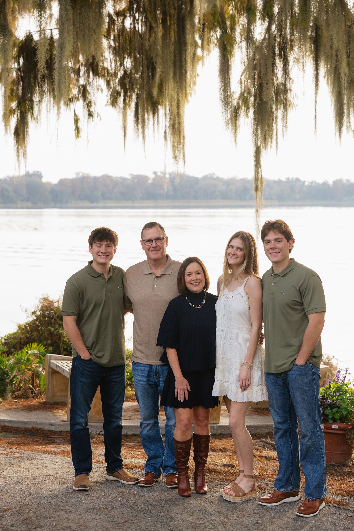 Family group photos taken outdoors with Spanish moss hanging from trees and water in the background.