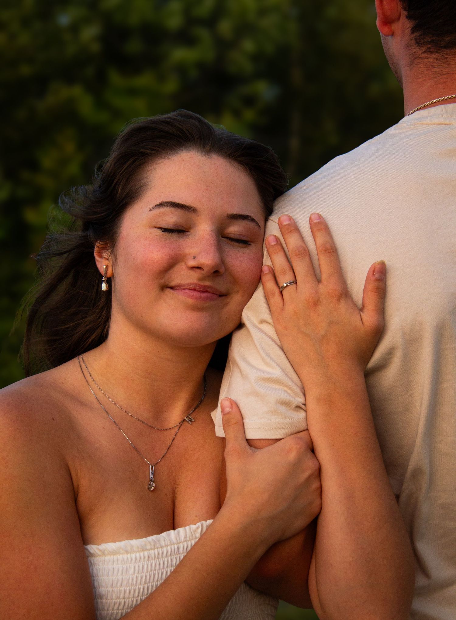 woman holding mans arm with eyes closed