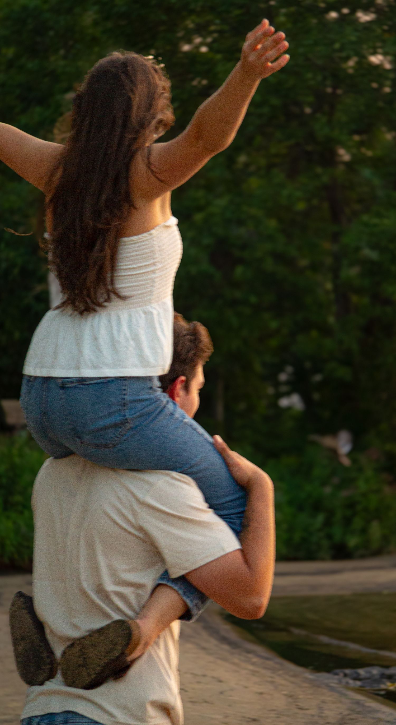 couple on the beach, woman is on the mans shoulders